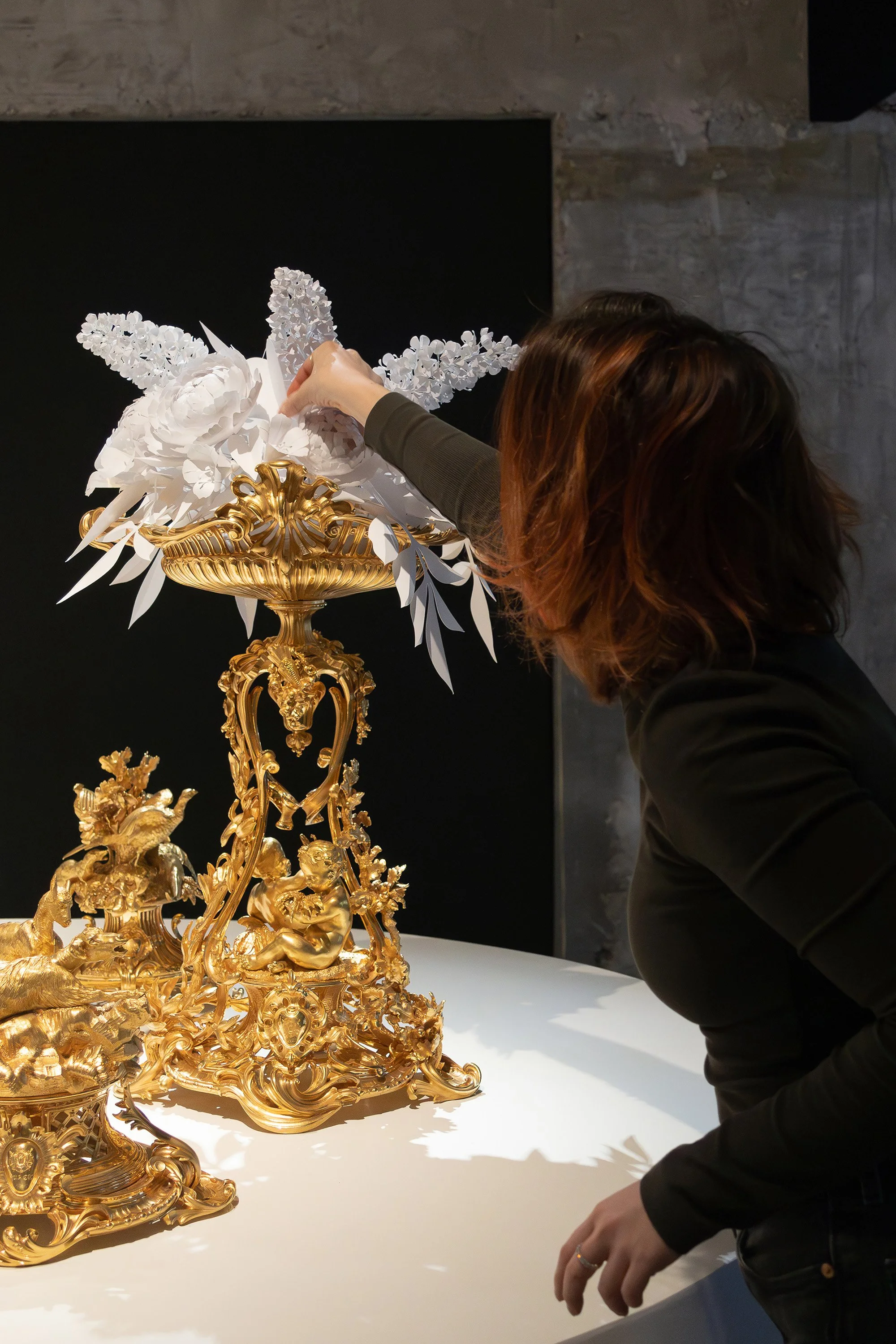 Paper artist Léa Dubreuil refining a white paper floral installation for Christofle at the Musée des Arts Décoratifs, Paris.