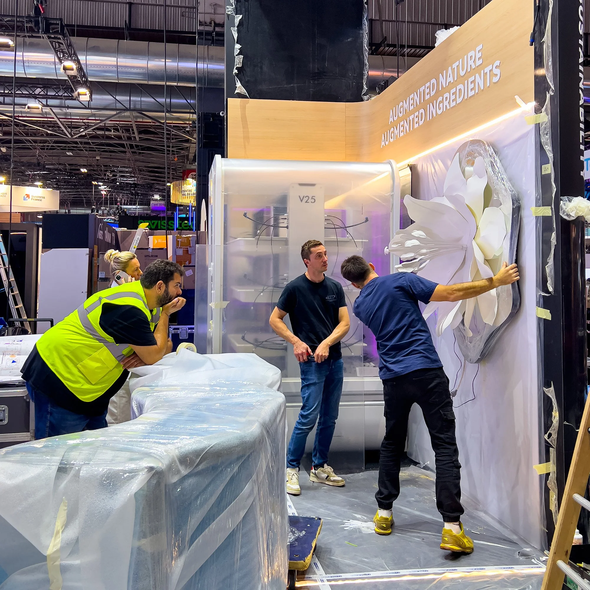 On-site installation of the illuminated botanical artwork during Vivatech setup.
