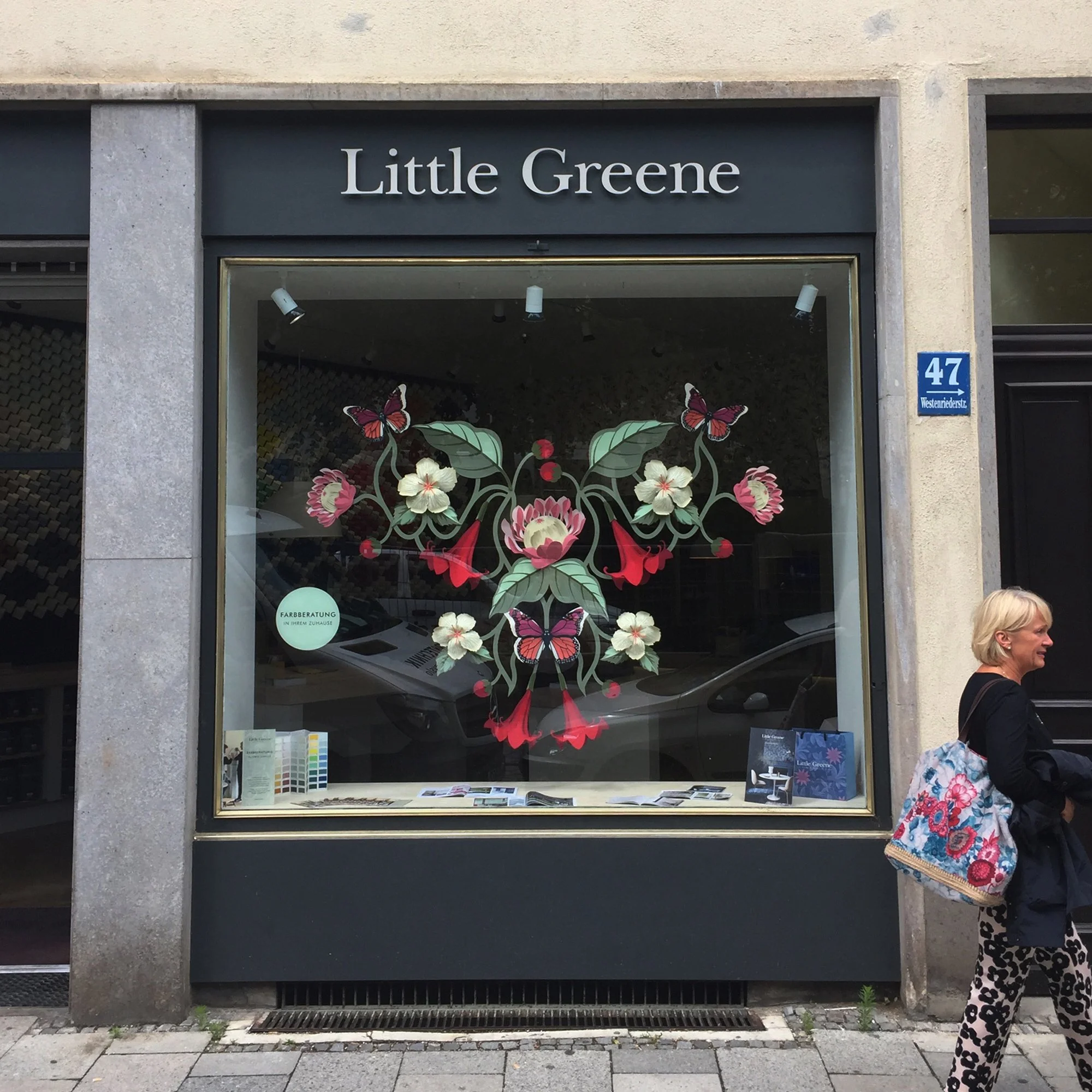 Hand-painted paper floral installation displayed in the Little Greene Munich showroom during Münchner Stoff Frühling