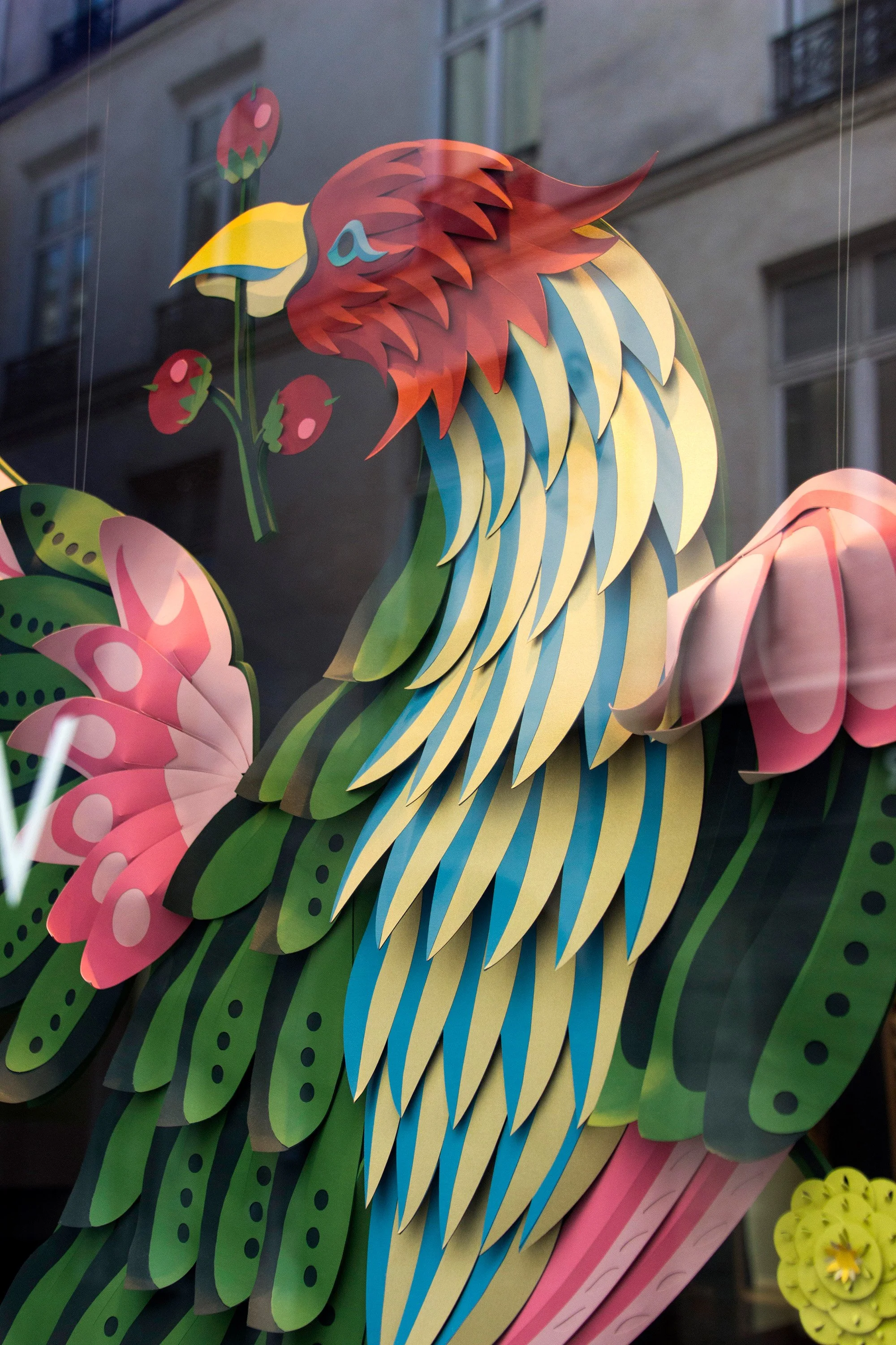 Close-up of hand-painted paper Bird of Paradise in window display, Paris