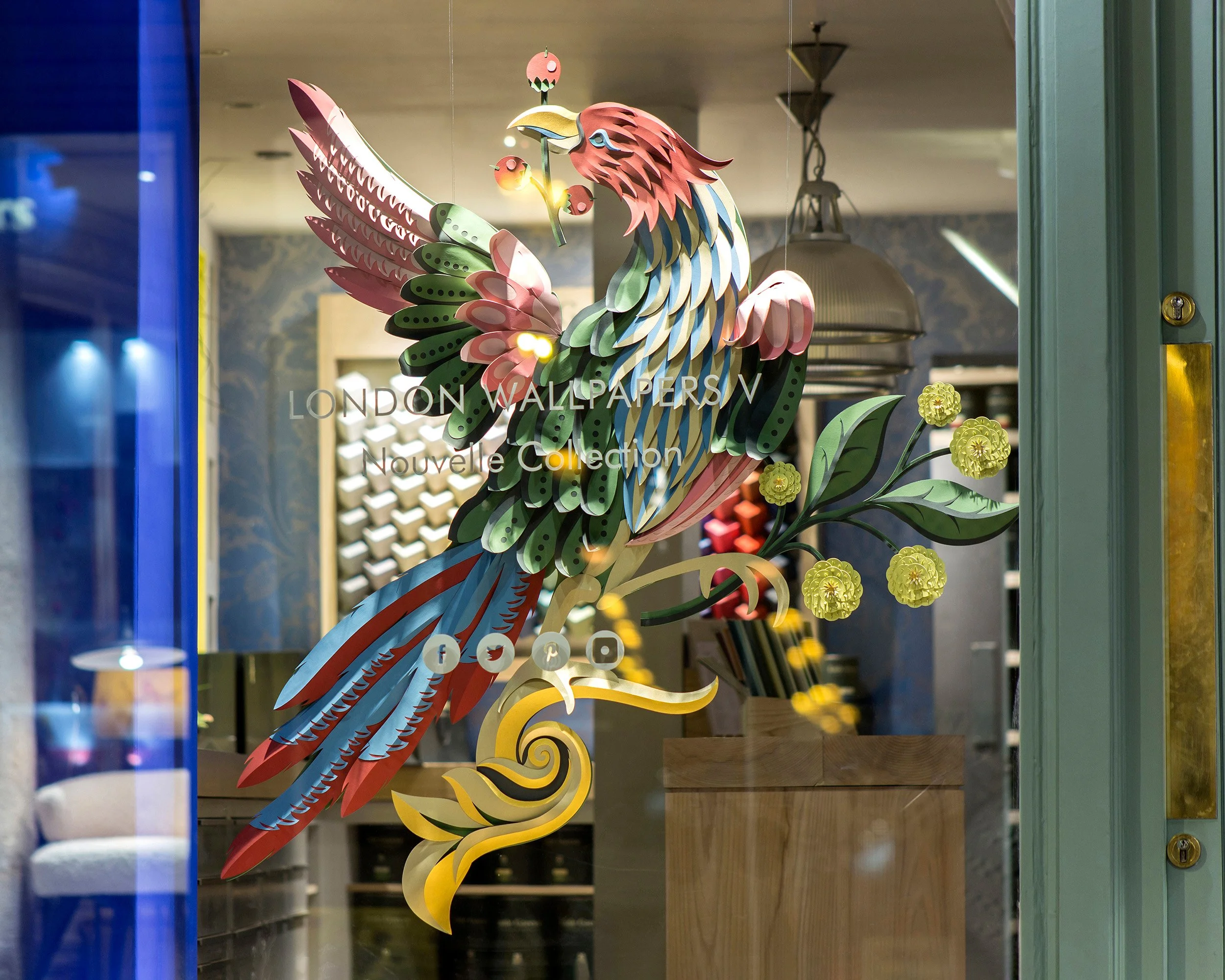 Hand-painted paper Bird of Paradise installation in Little Greene showroom window, Paris