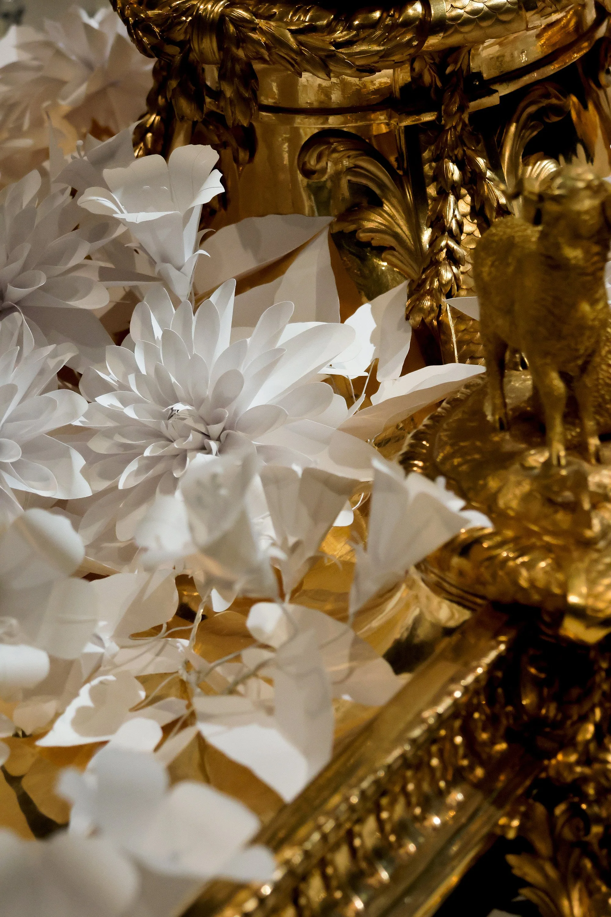White paper dahlias and delicate bindweed blossoms nestled within the ornate gilded Christofle central jardinière, Musée des Arts Décoratifs, Paris.