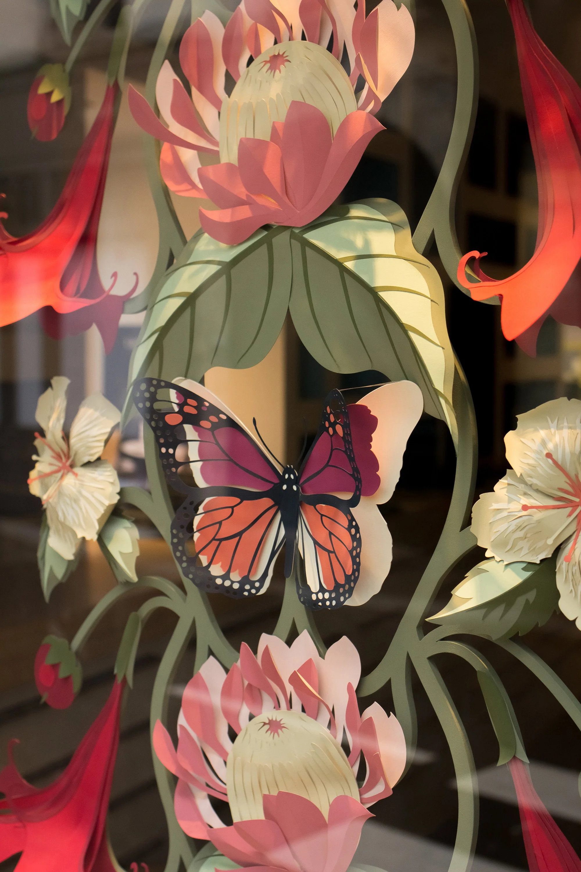 Hand-painted paper butterfly within a layered floral installation for Little Greene