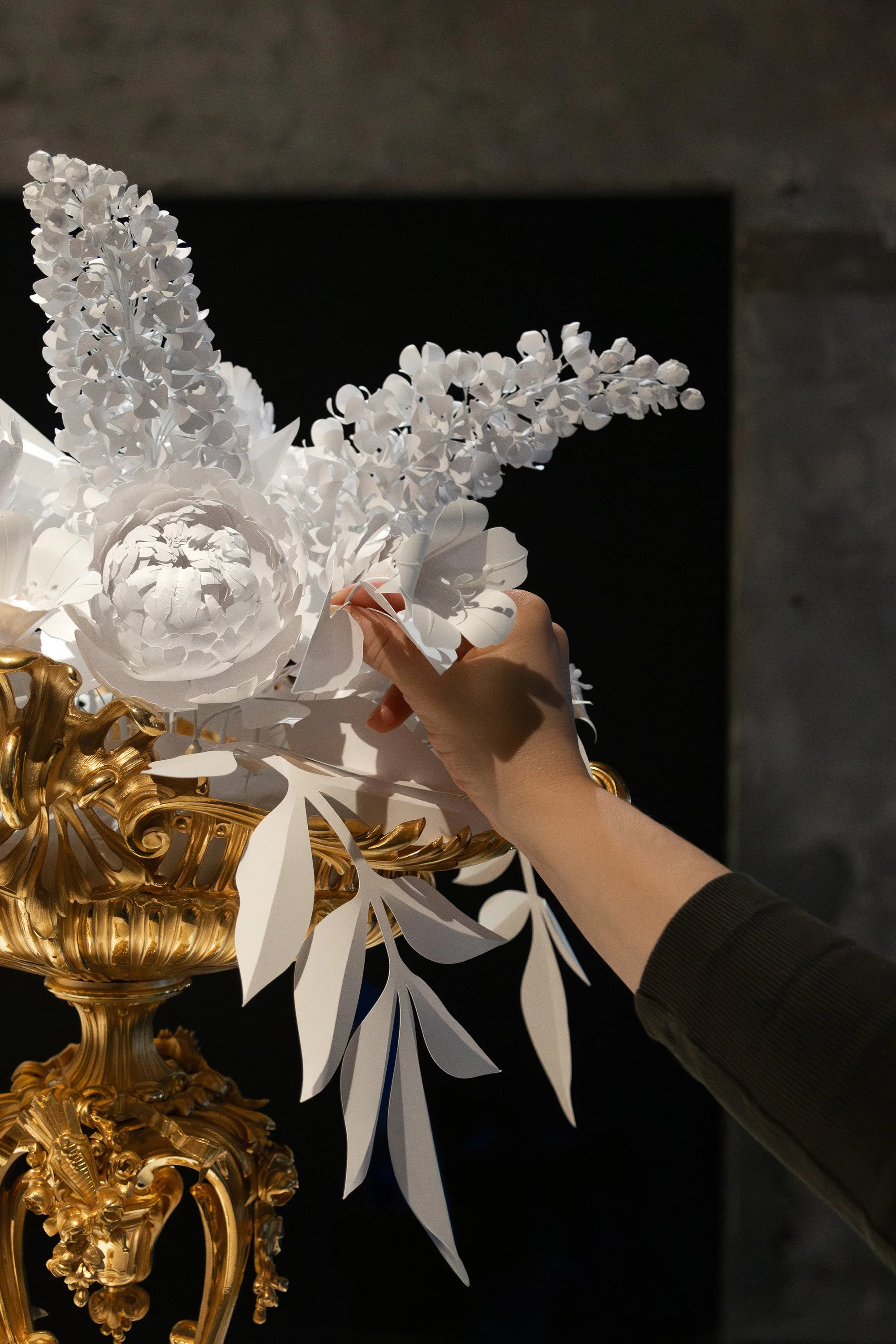 White paper floral installation placed in a gilded Christofle basket at the Musée des Arts Décoratifs, Paris.