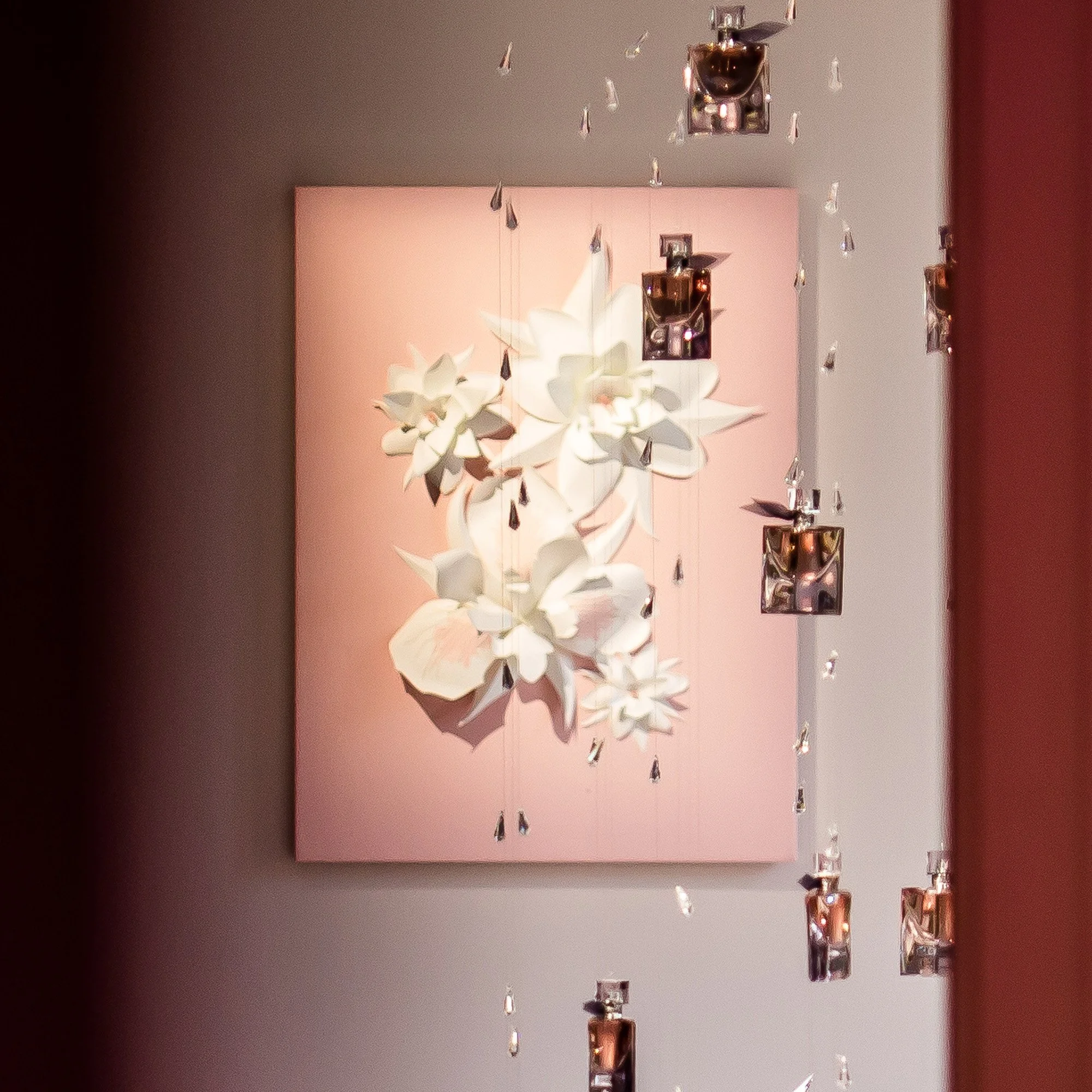 Suspended fragrance bottles and paper floral composition inspired by La Vie Est Belle