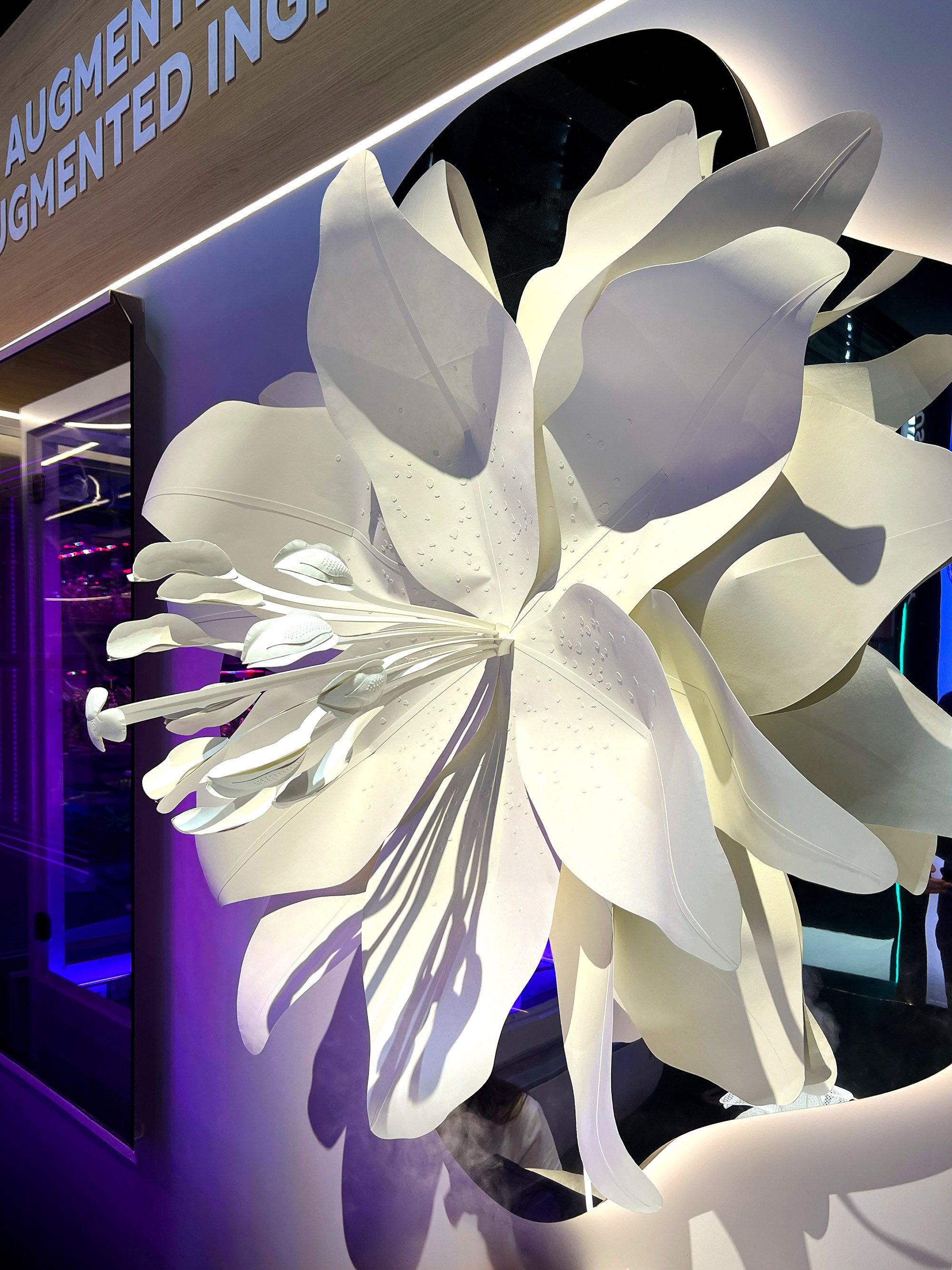 Close-up of handcrafted botanical paper sculpture with illuminated petals.