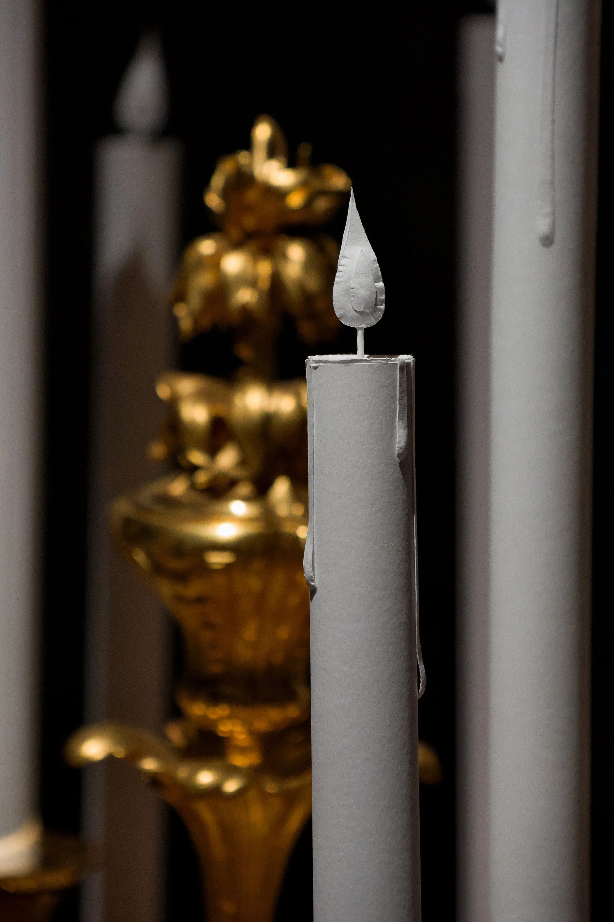 Handcrafted white paper candle detail installed on a Christofle candelabra at the Musée des Arts Décoratifs, Paris.