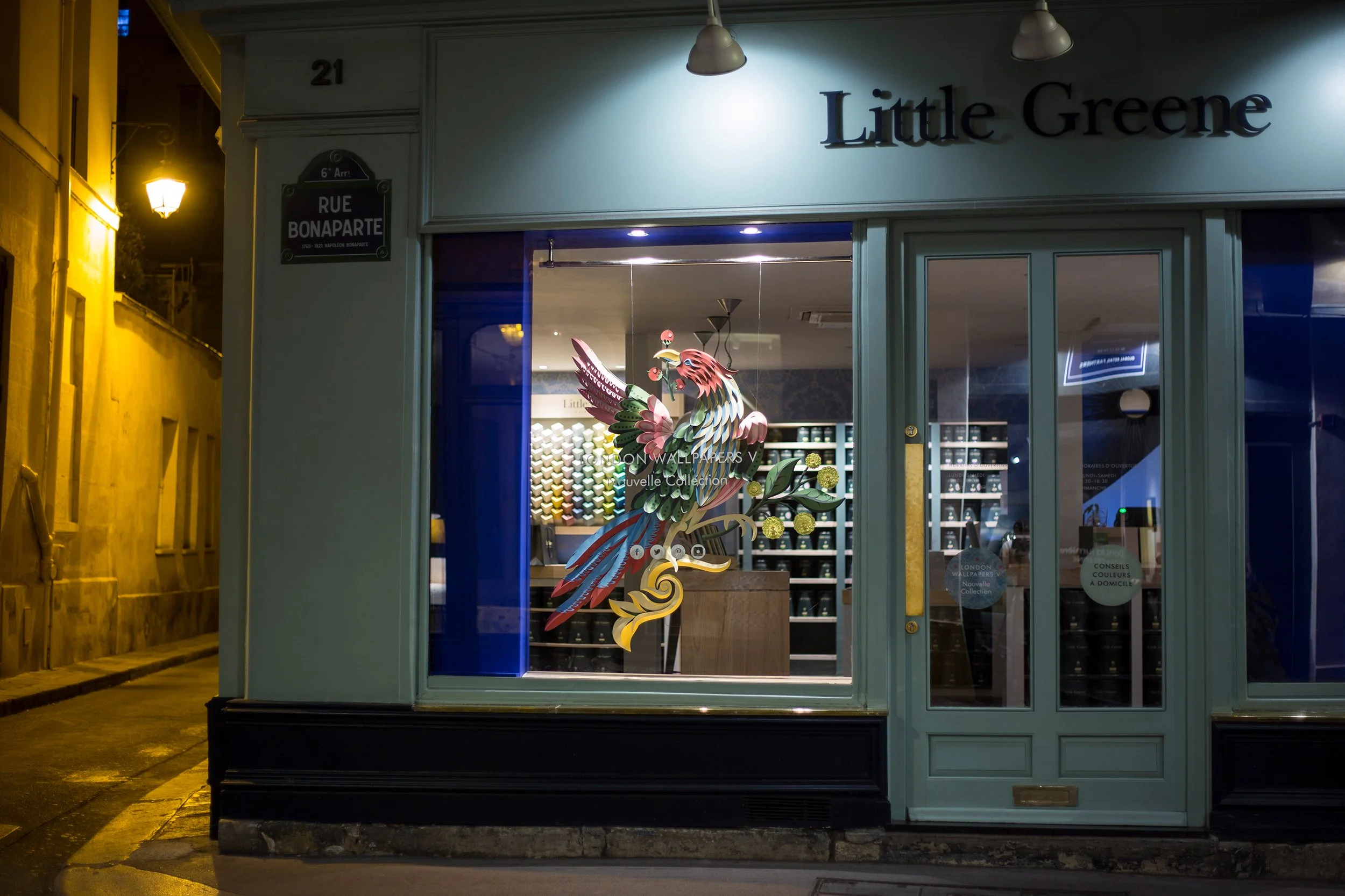 Night view of Little Greene window display with Bird of Paradise paper installation