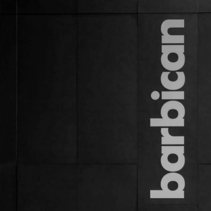 Close-up of a wall with the word 'barclays.com' written vertically in large, white letters.