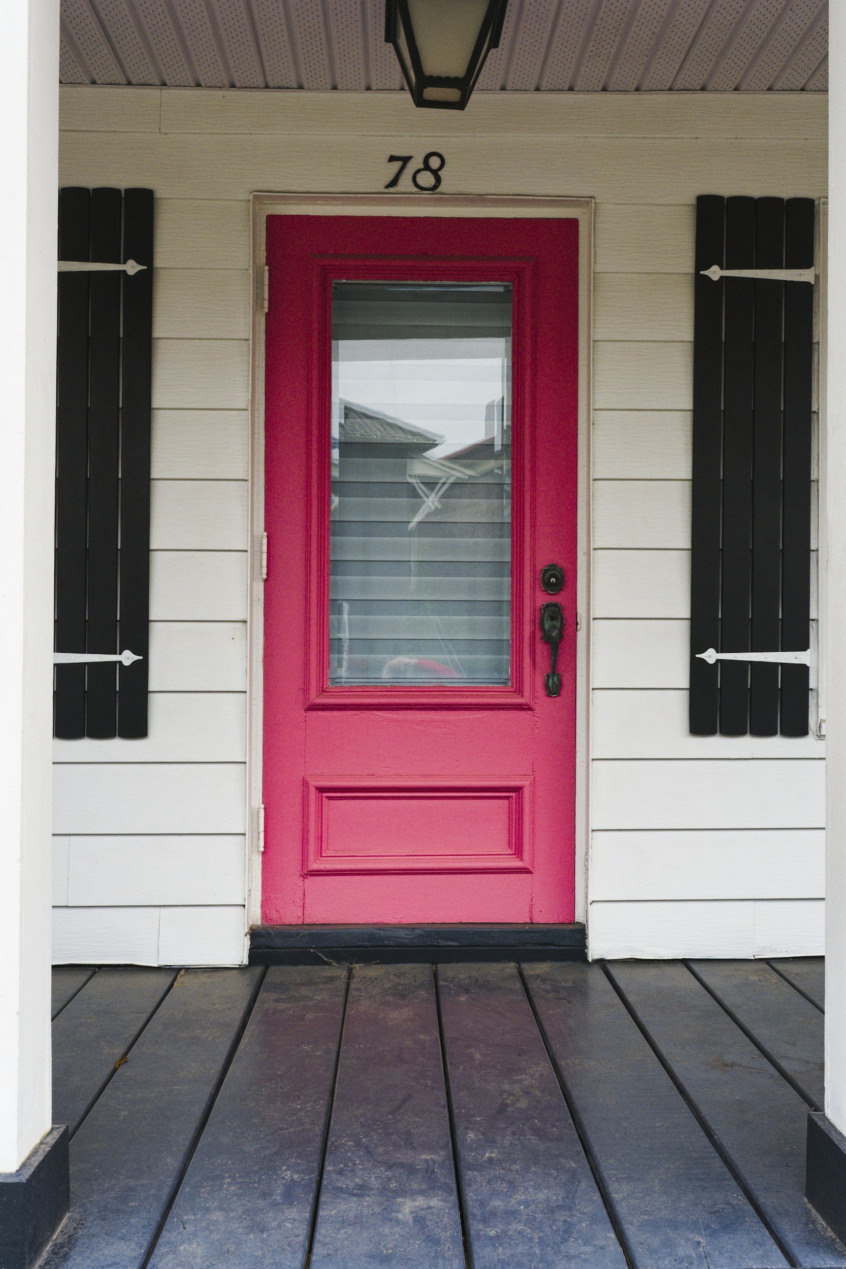 porch of a white house with a red front door