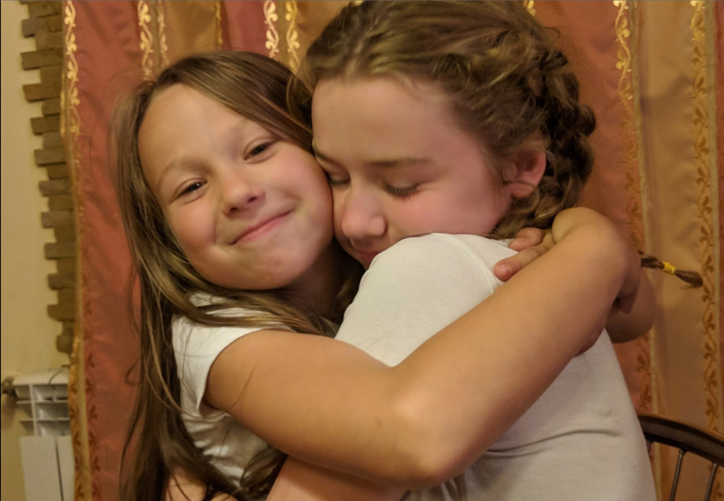 Ukrainian and American girl hugging