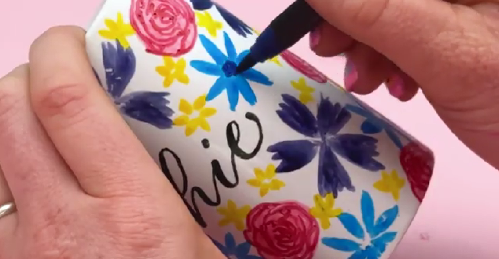 Adding contrasting coloured centres and fine details to hand-painted ceramic flowers