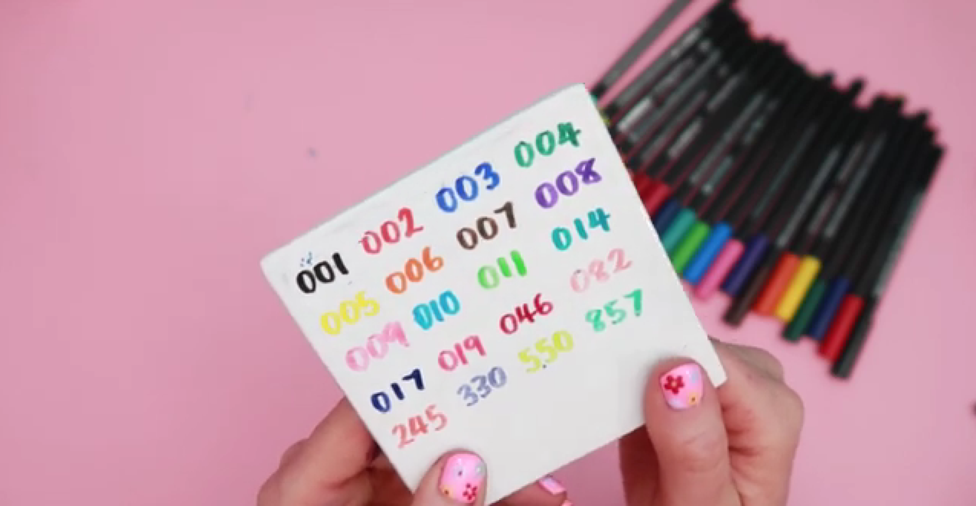 Colour swatches of porcelain paint pens on ceramic surface showing opacity and pigment before baking