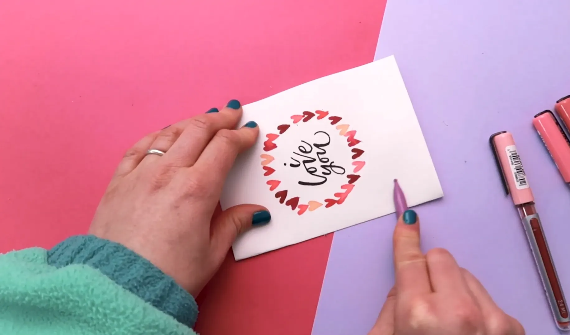 Folding handmade Valentine’s card using bone folder