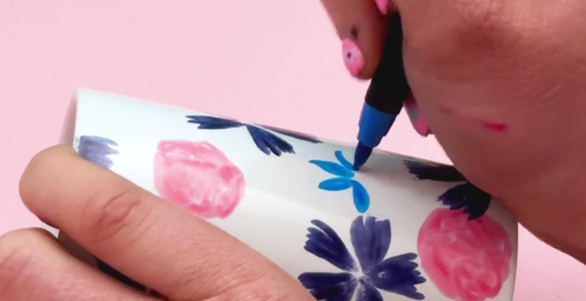 Creating small blue layered flowers with teardrop shaped petals on ceramic surface