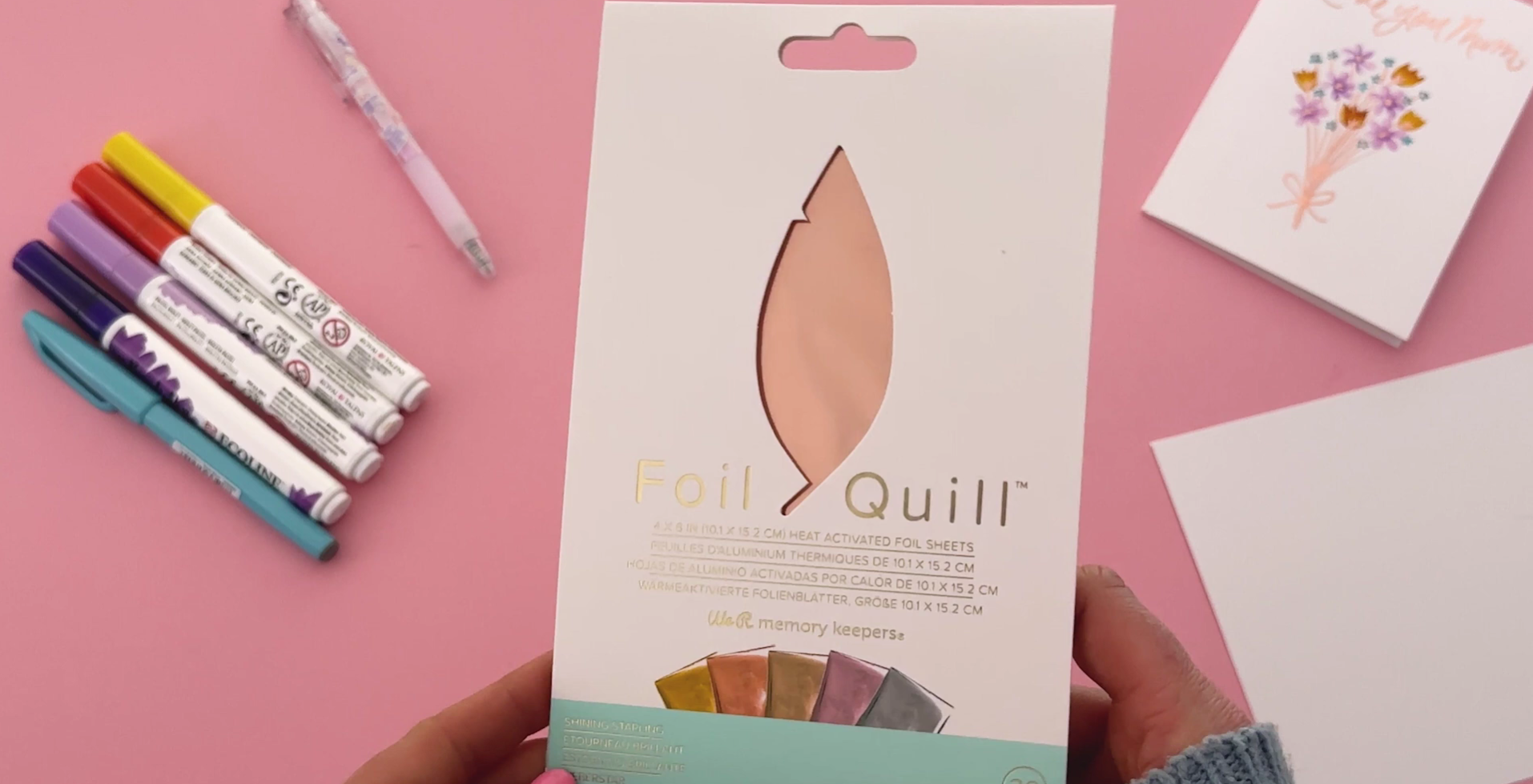 Brush pens, glue pen, foil and card stock used for handmade Mother’s Day card