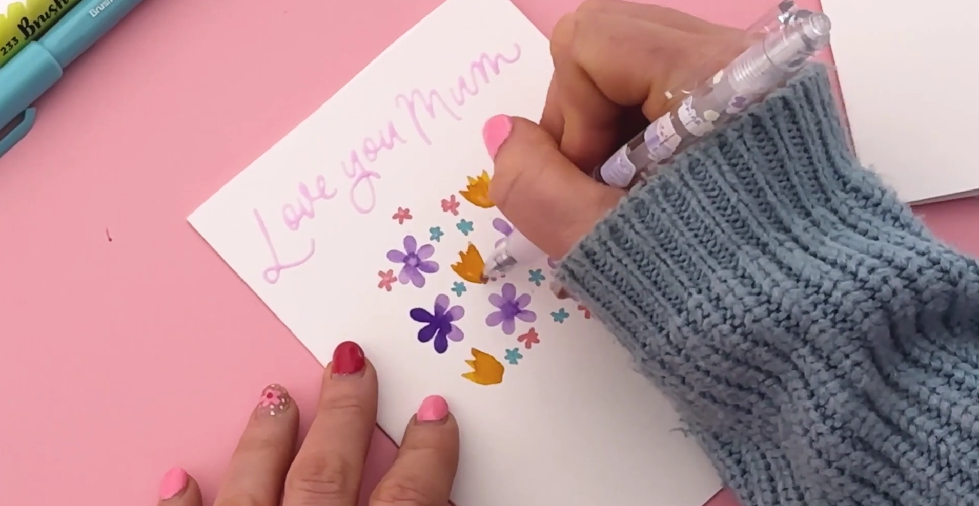 Adding glue pen details and stems to a floral bouquet