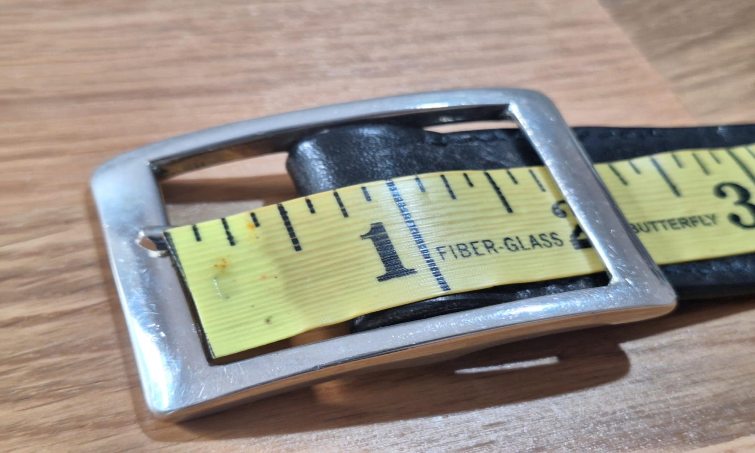 Measure from the inside of the far end of the buckle.