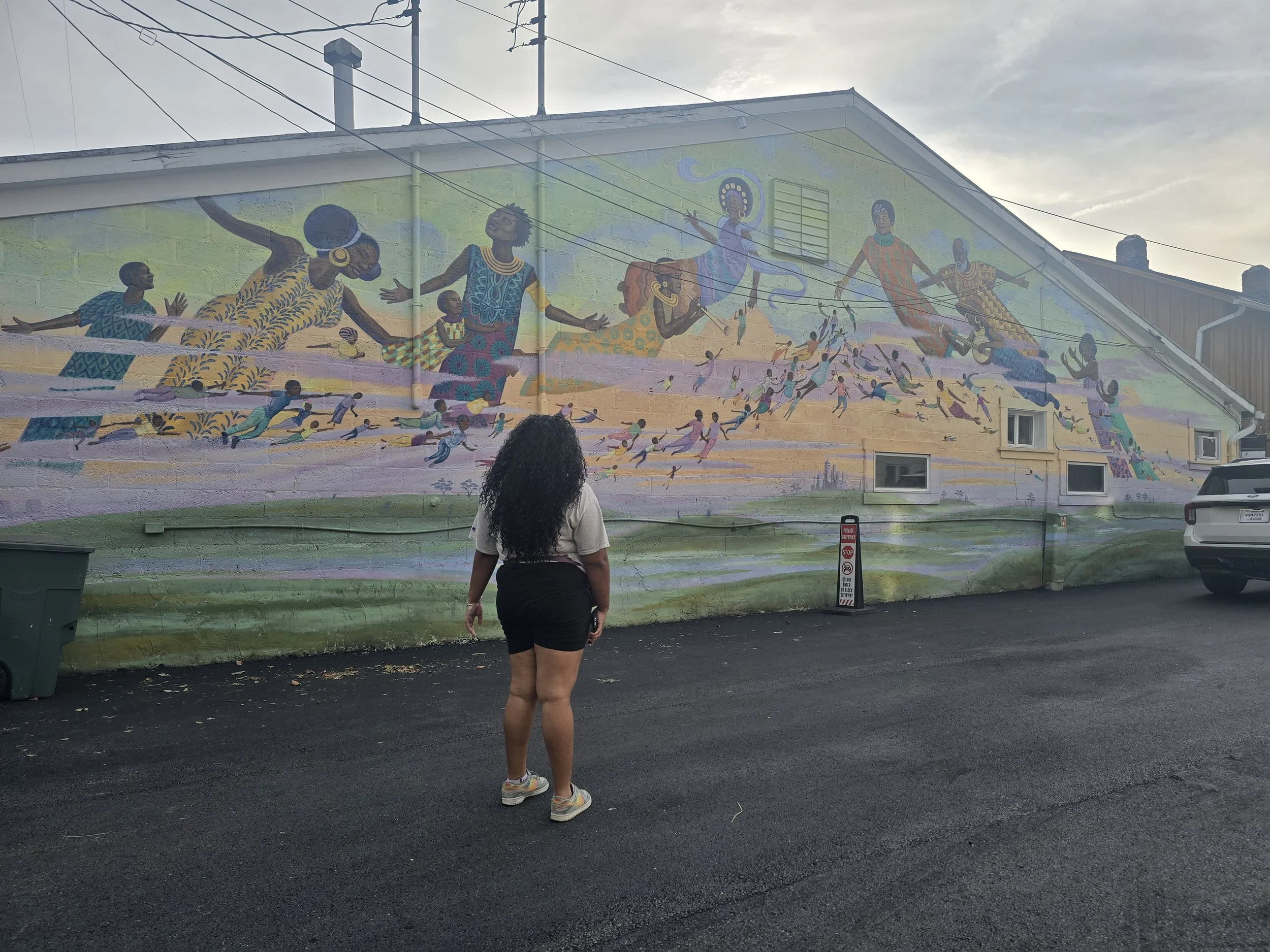Queens Club Coordinator, Shayla Card-Nowlin, taking in a stunning mural in Yellow Springs, OH during the Annual Transformational Fieldtrip 2026. 