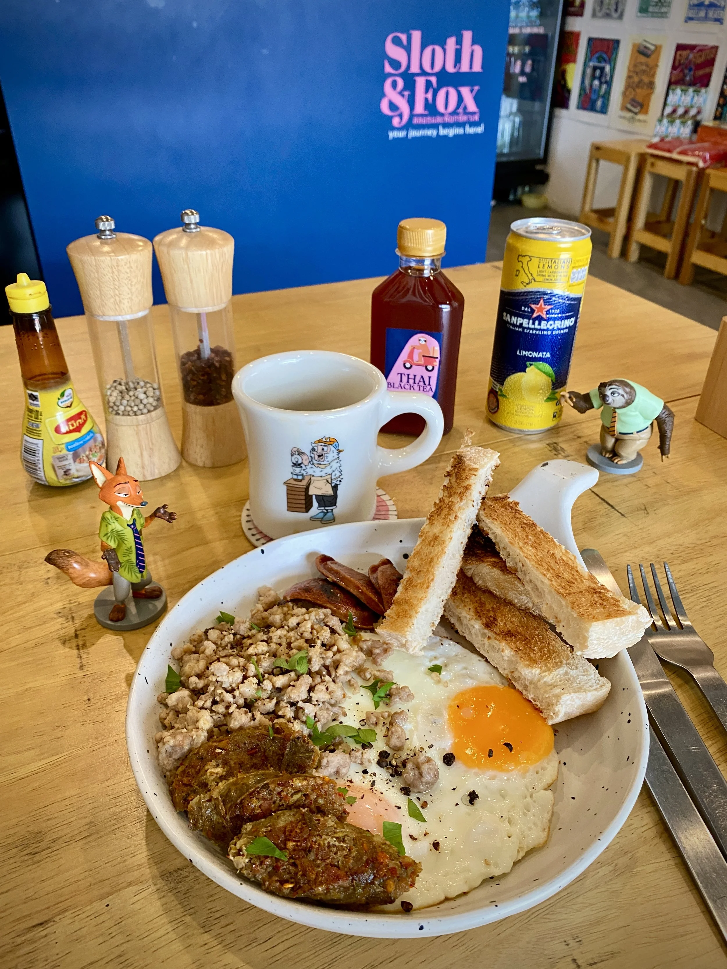 #12 Thai Khai Kata Toast | ไข่กะทะโปรตีนล้น | Two farm-fresh fried eggs with Chiang Mai sausage, Chinese sausage & seasoned minced pork, sprinkled with herbs on toast. ไข่ดาวสองฟอง ไส้อั่วเชียงใหม่ กุนเชียง หมูสับ และสมุนไพรหอมๆ บนขนมปัง 🌶️🏆