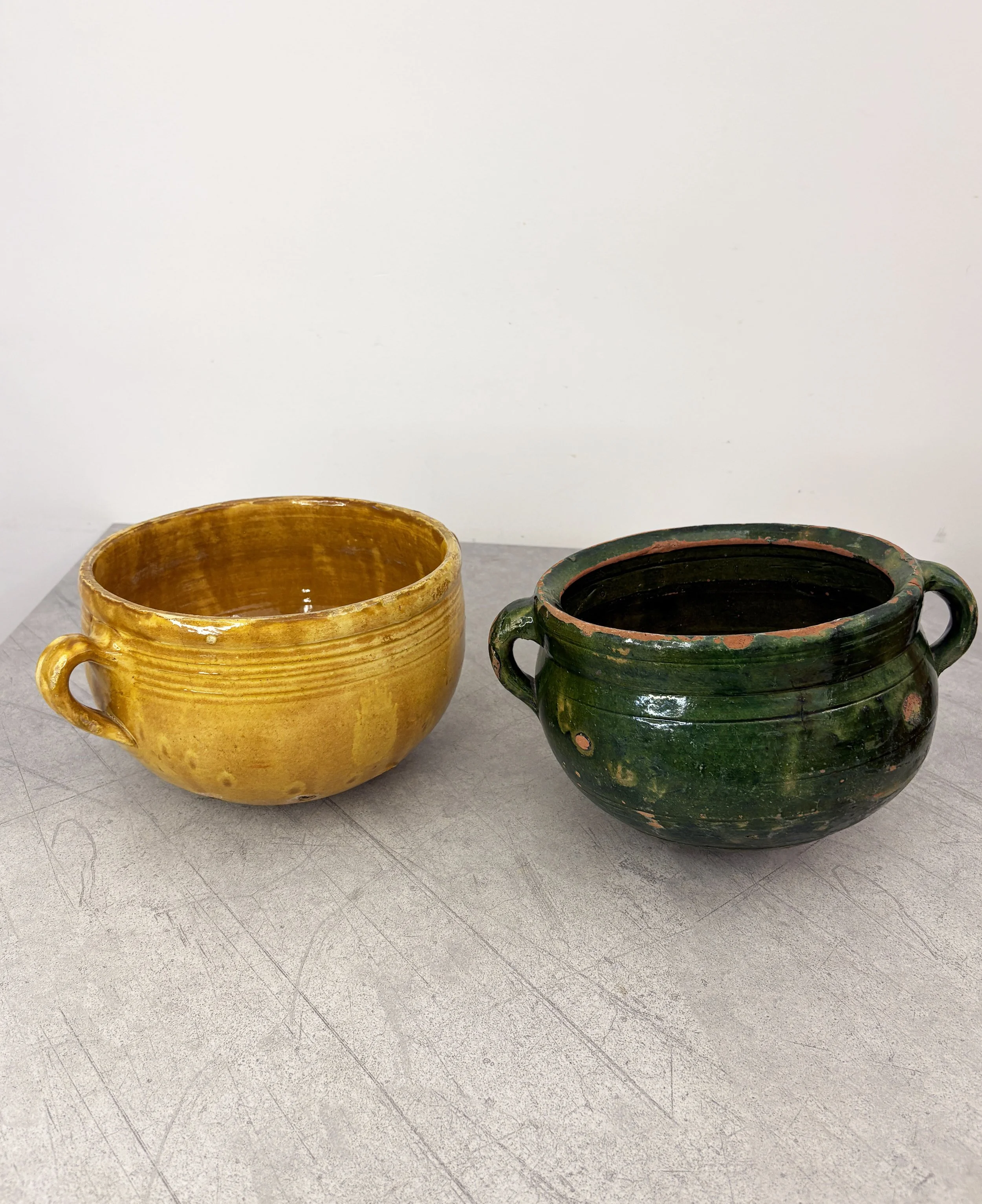 antique green and yellow ceramic colanders