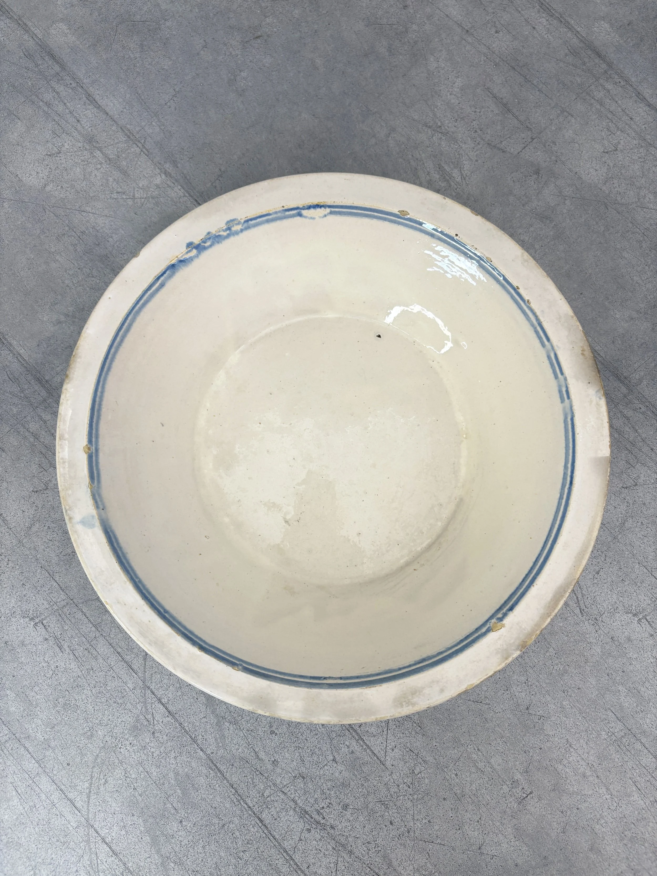 large antique white bowl with blue stripe