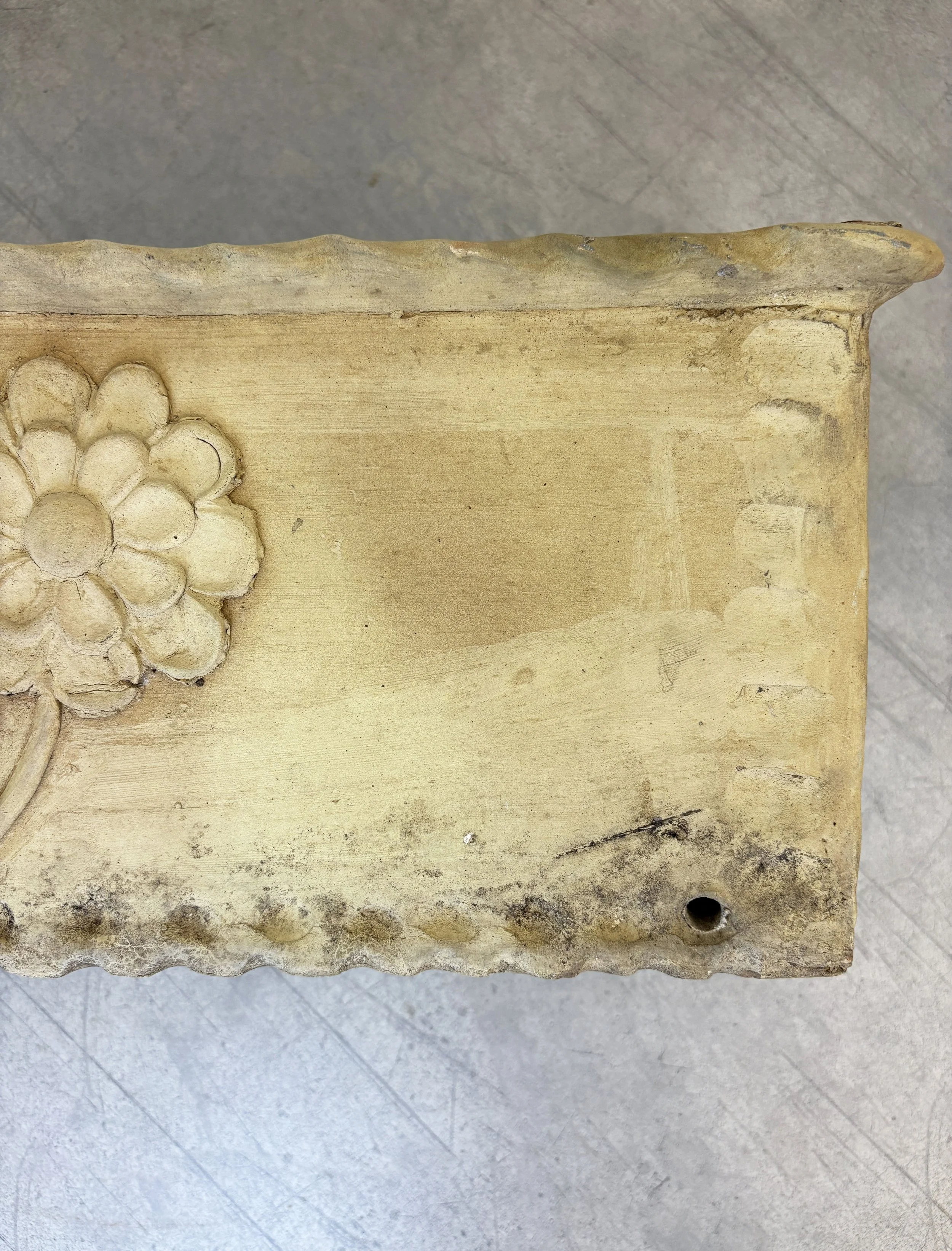 antique planter with flower motif