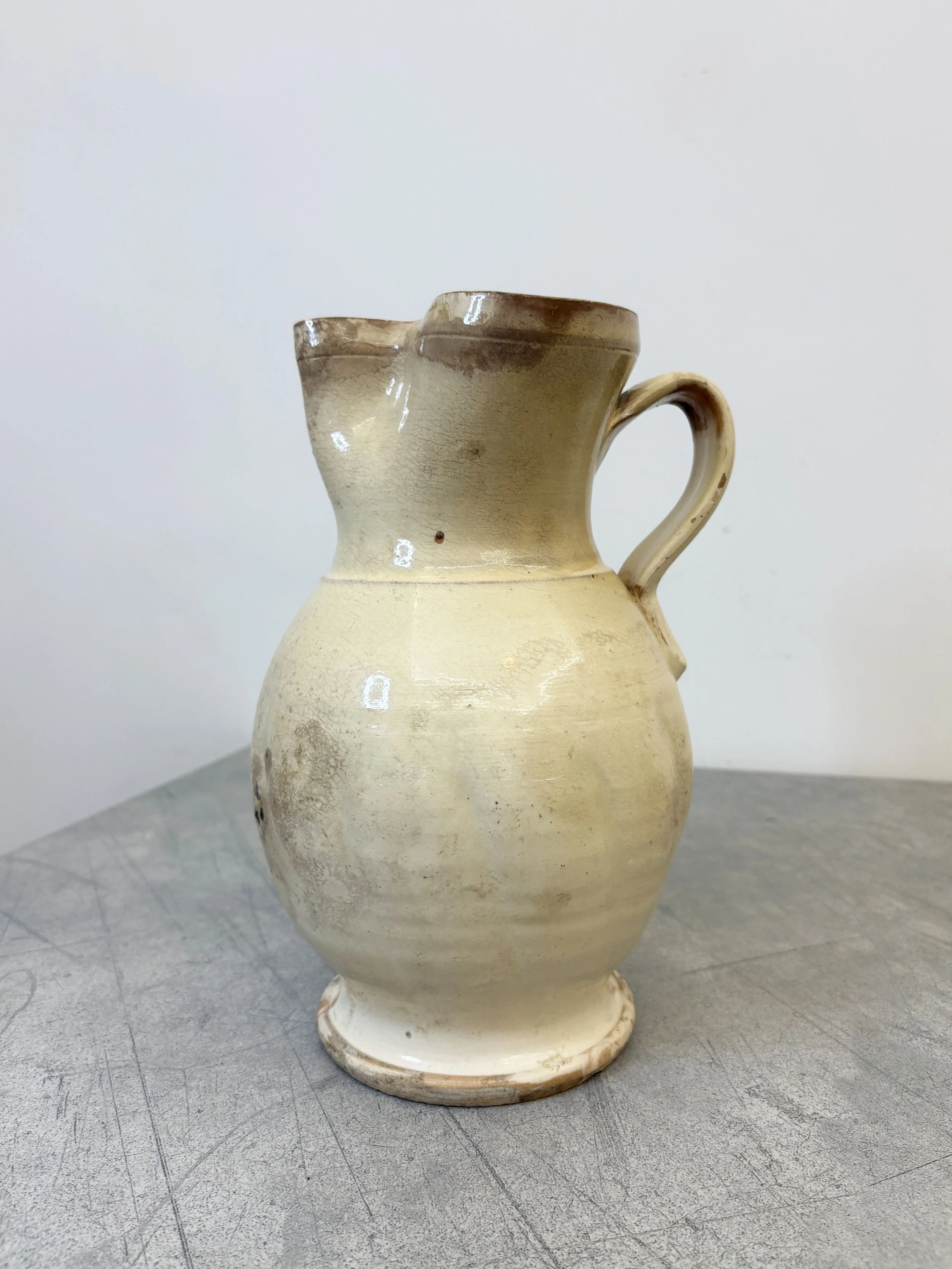 antique white glazed ceramic pitcher