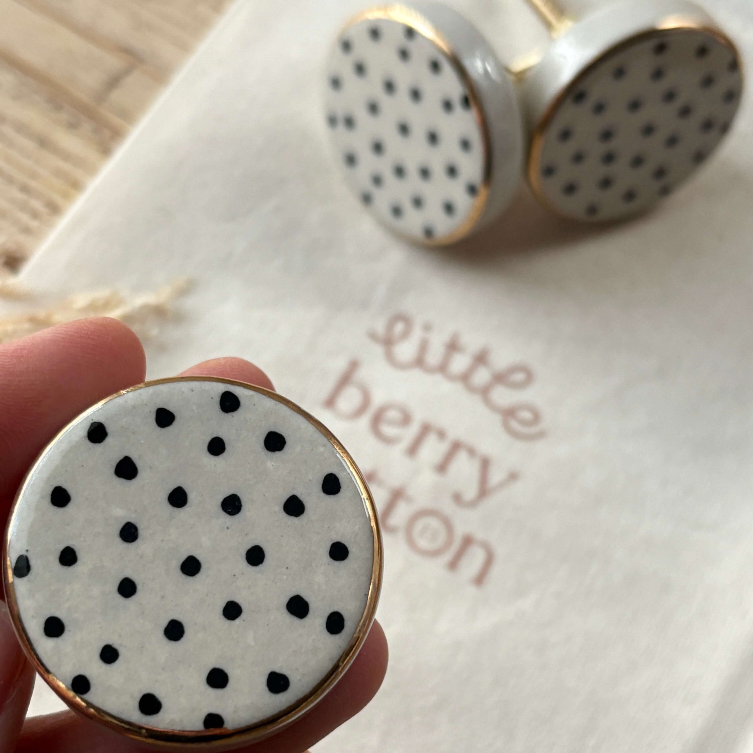 black and white spotty drawer knobs with gold edge detail