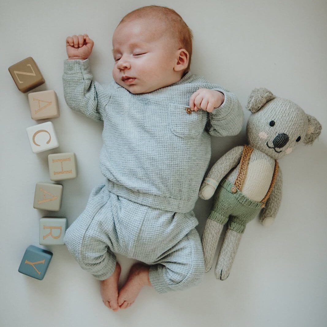 Little Berry Button baby name blocks next to baby Zachary. Personalised baby blocks that make a perfect nursery accessory, unique gift for baby showers, Christenings, and birthdays