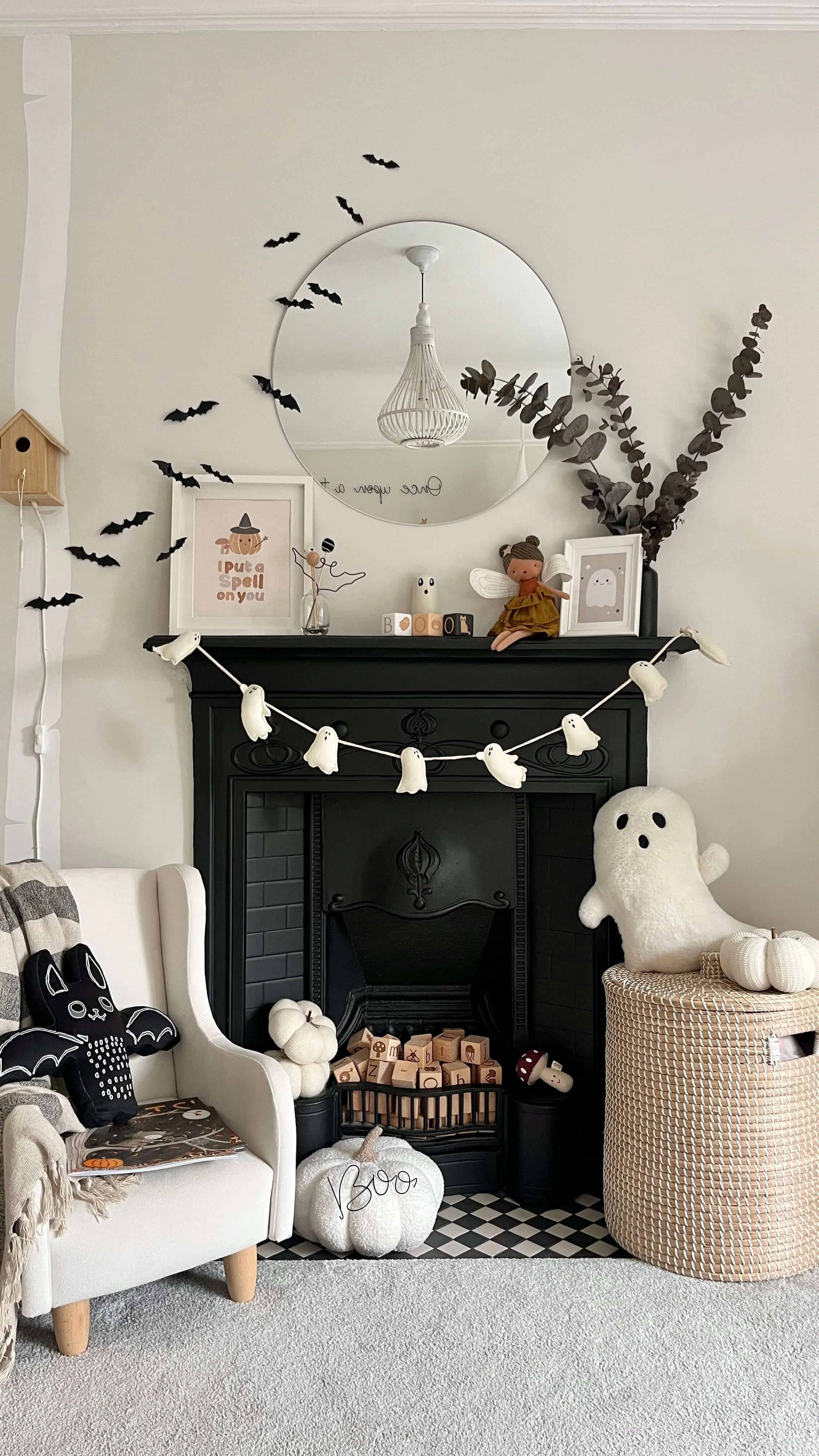 kids bedroom halloween display with spooky decor accessories around black fireplace