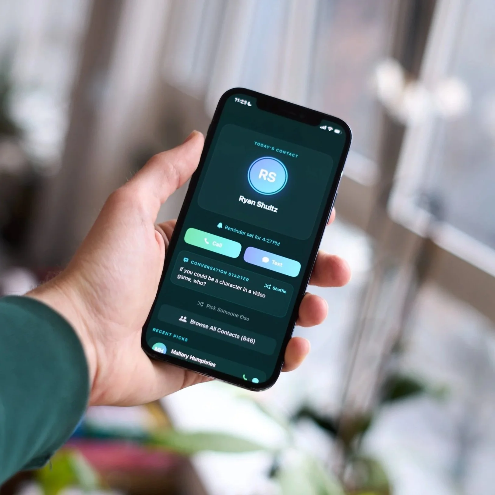 a hand holding a phone with the Penelope app on it