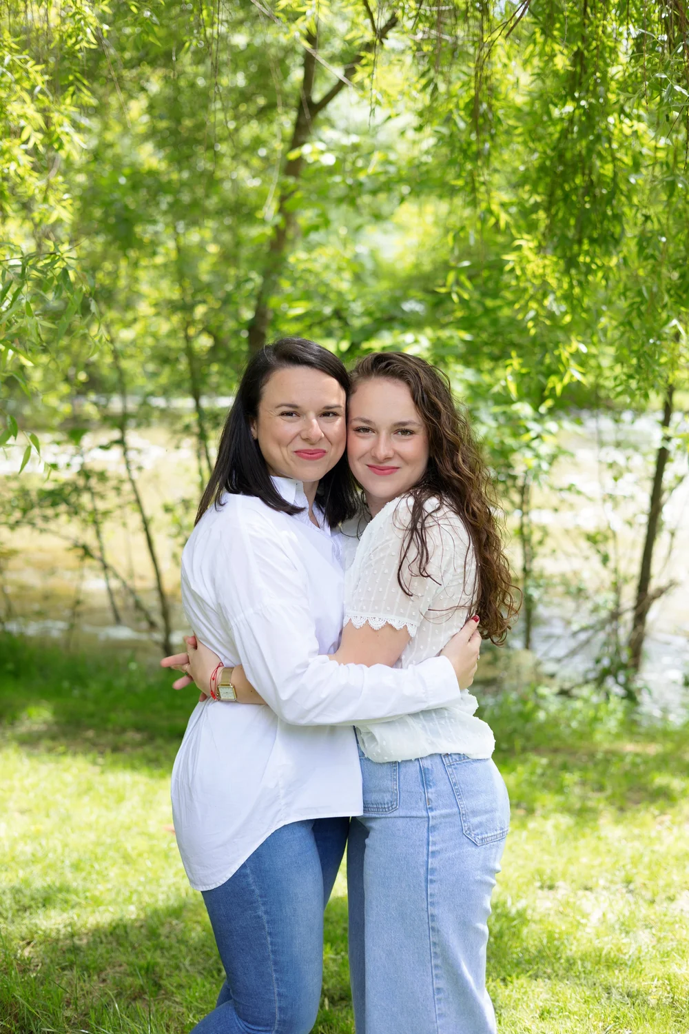 Deux sœurs enlacées au bord d’un lac.