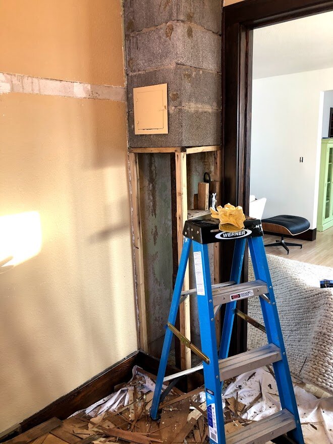 A half chimney used when there was a wood burning stove in the living room was covered with wallpaper and paneling. I started to pick at it....