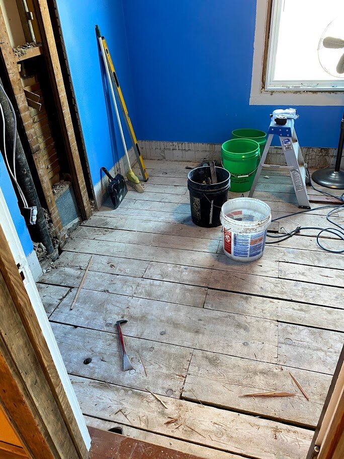 The wood floor is removed from one of the bedrooms upstairs. The wood will be repurposed as window trim where white mdf trim was removed.