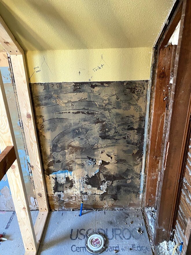 Toilet room is created by dividing wall. The toilet didn't actually move but changed rooms by adding a wall on one side and a doorway on the other.