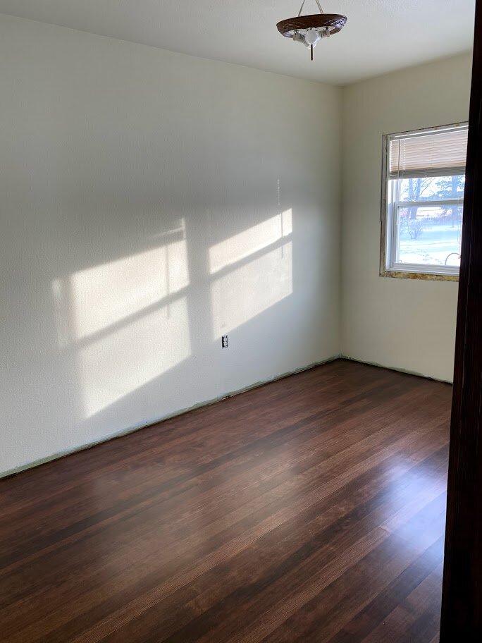 The fir floor refinished in one room on the main floor. This is the floor that was covered in sheet vinyl and glue. What a treasure hiding beneath all of that! The paint color has been changed to brighten up the space. Finishing the trim and chang