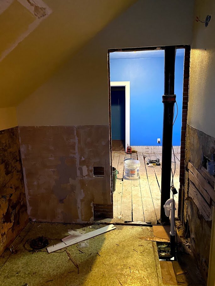 A door has been cut through the existing bathroom to the middle bedroom to create a larger bathroom. The stack has been replace and moved.