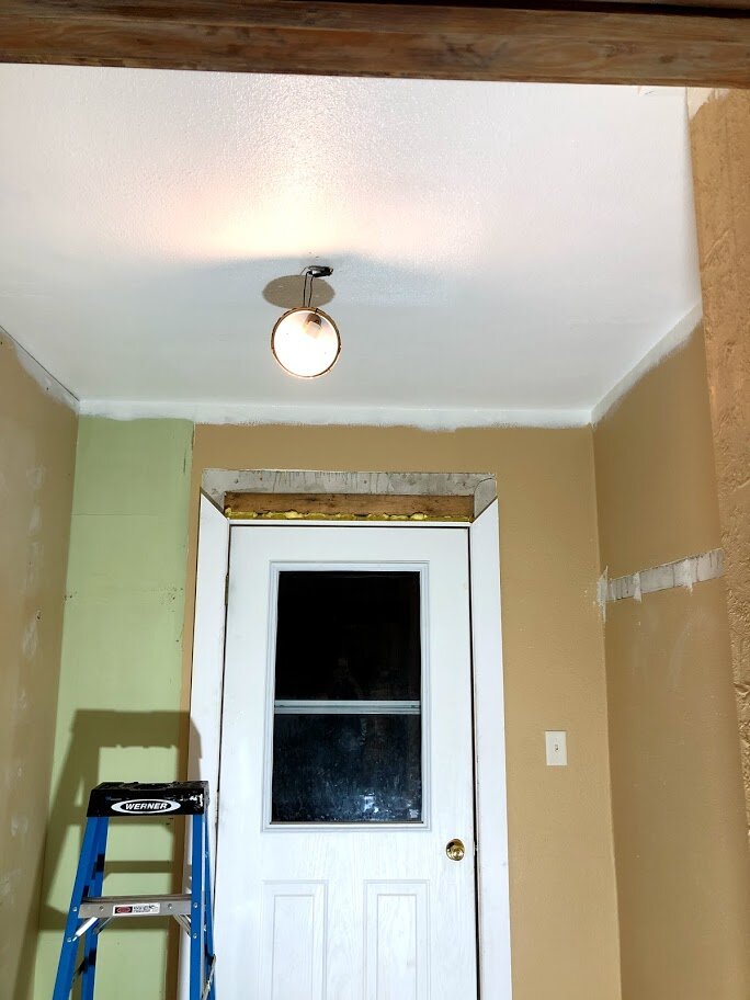 Front entrance built-ins have been removed and the ceiling painted.
