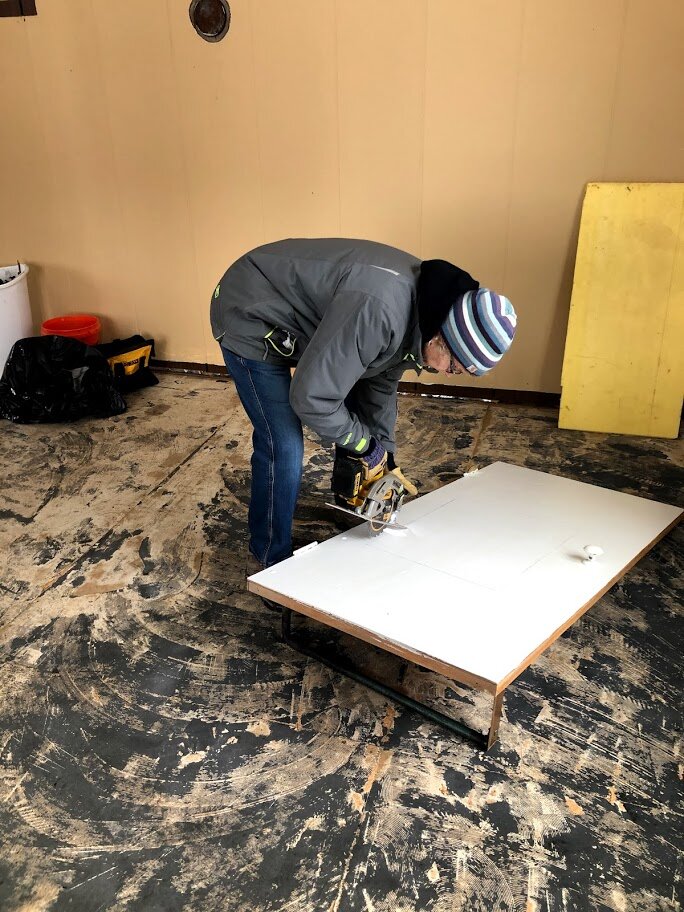 Brenda is making a cover for where the air conditioner was.