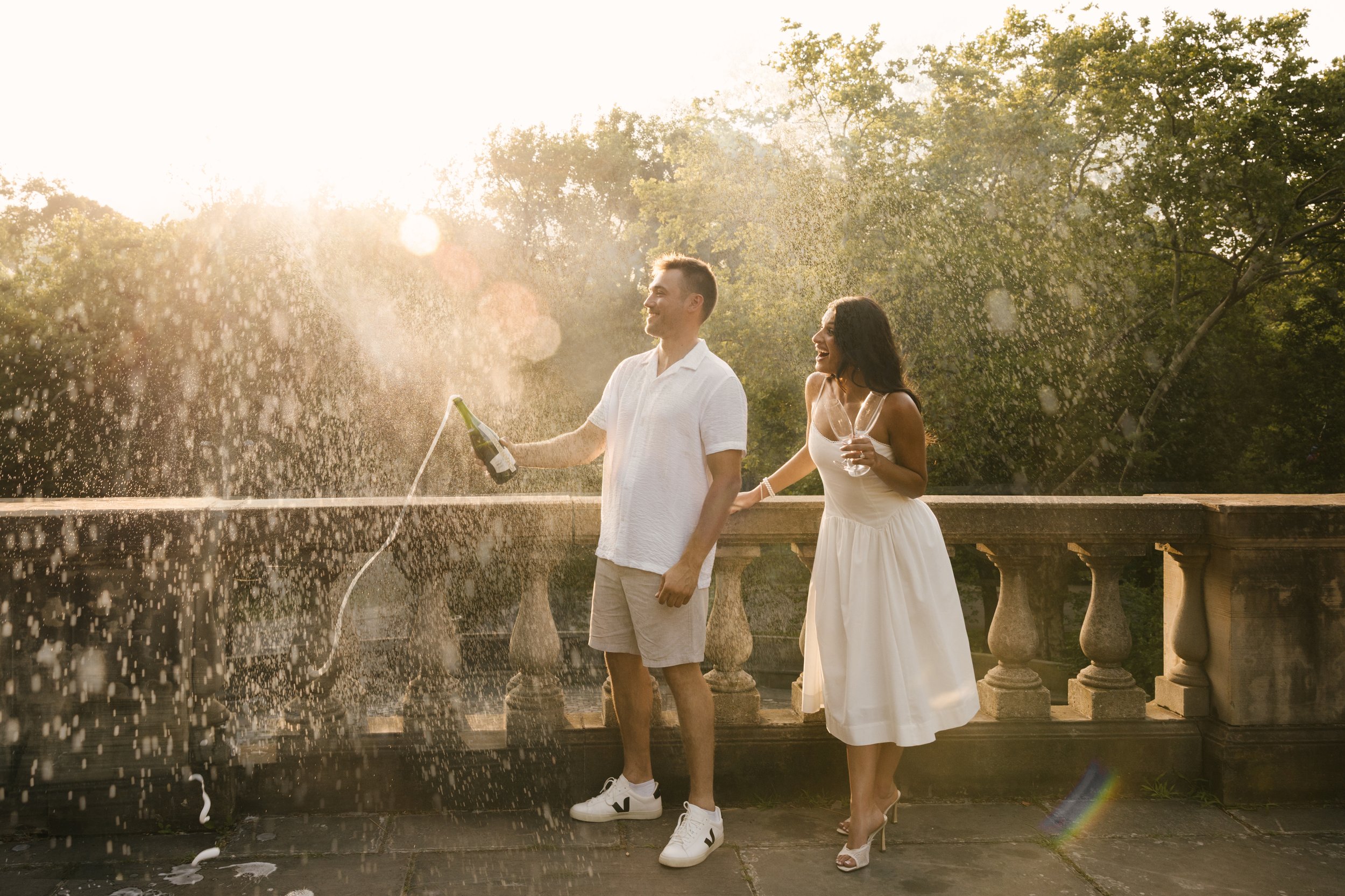 Couple popping champagne