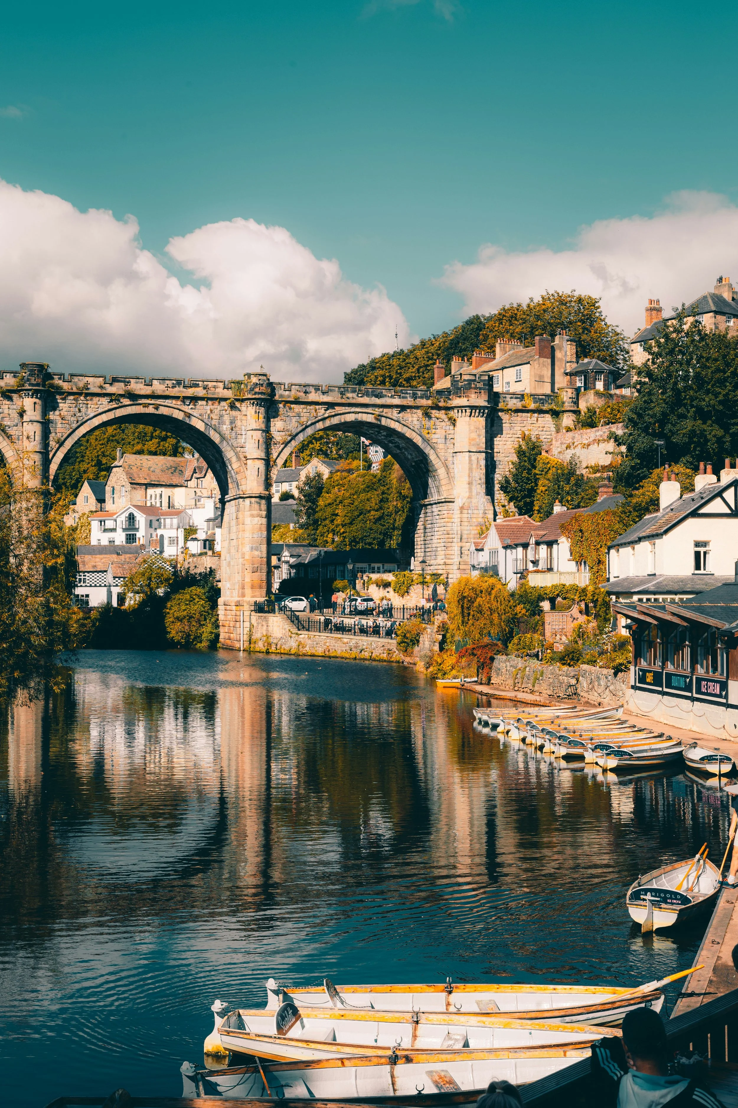 Image of the viaduct and riverside at Knaresborough with lots of boats moored.