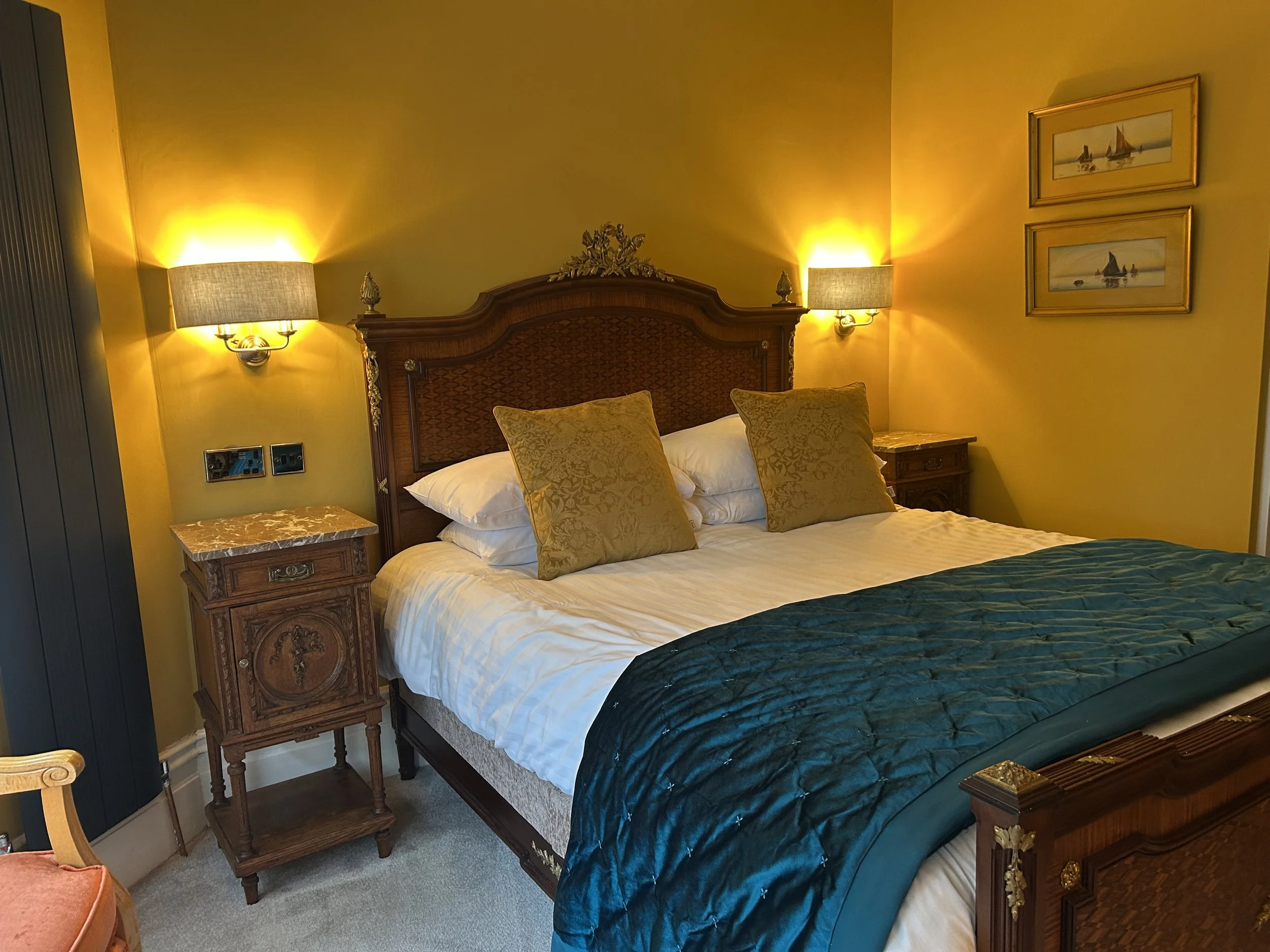 Bed and side tabkes with wall lights switched on