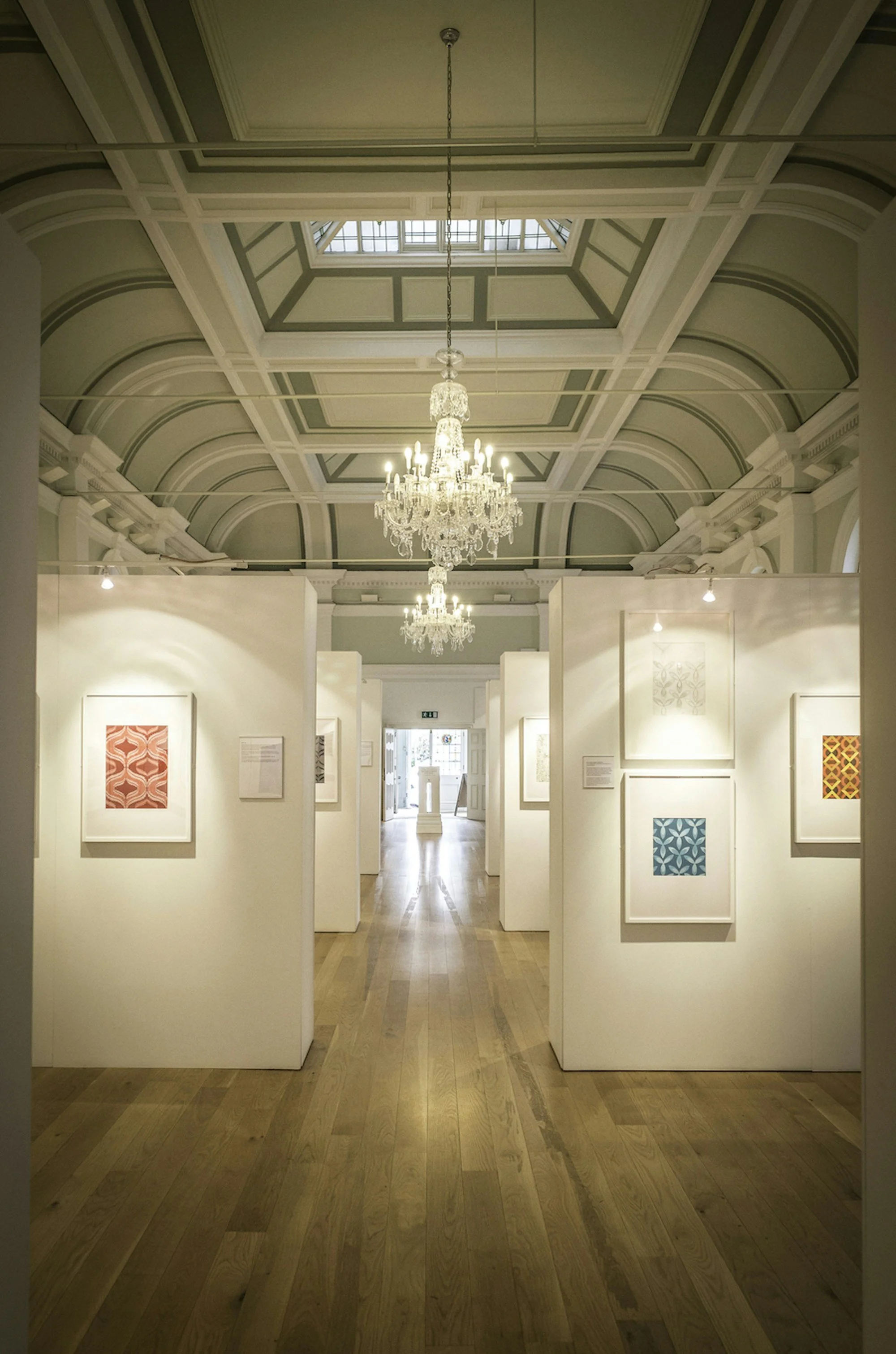 Interior view of the Mercer Art Gallery with chandelier and art works on display