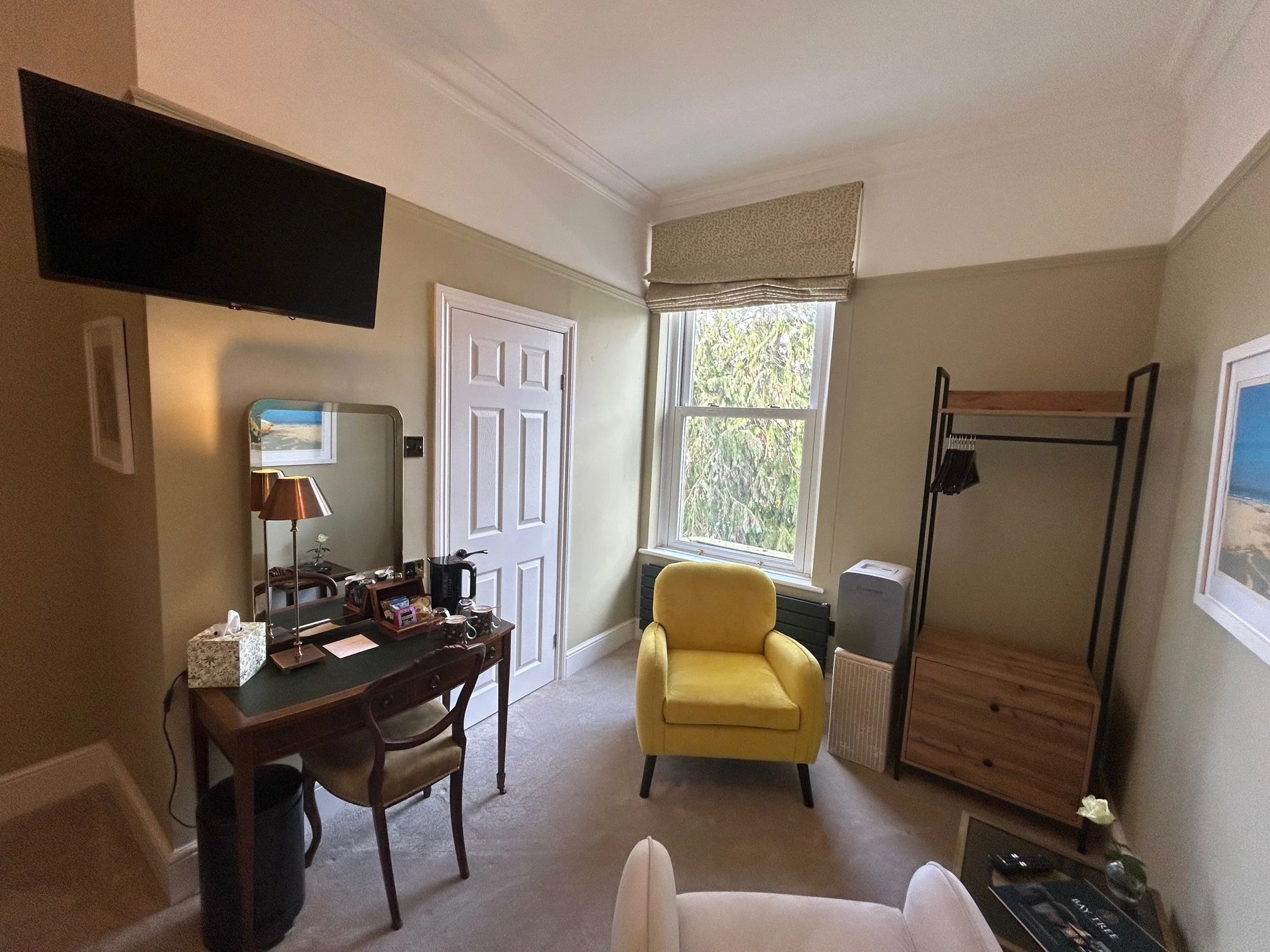 A large wall-hung TV and dressing table that can work as a desk too