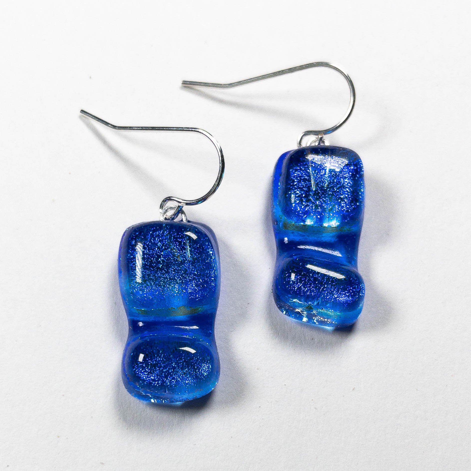 Pair of square-shaped cobalt blue fused dichroic glass earrings from the Zing! collection on sterling silver hooks