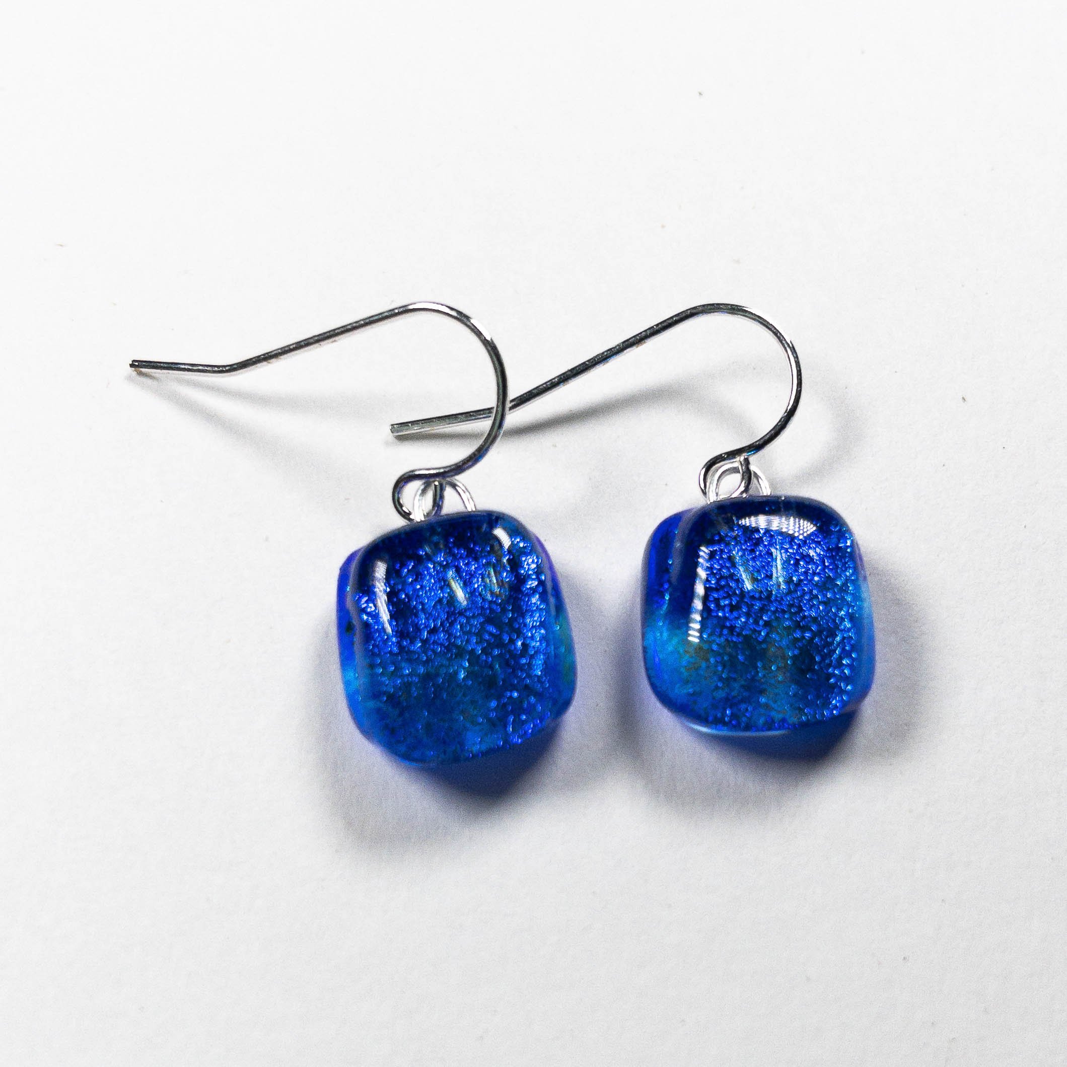Pair of square-shaped cobalt blue fused dichroic glass earrings from the Zing! collection on sterling silver hooks