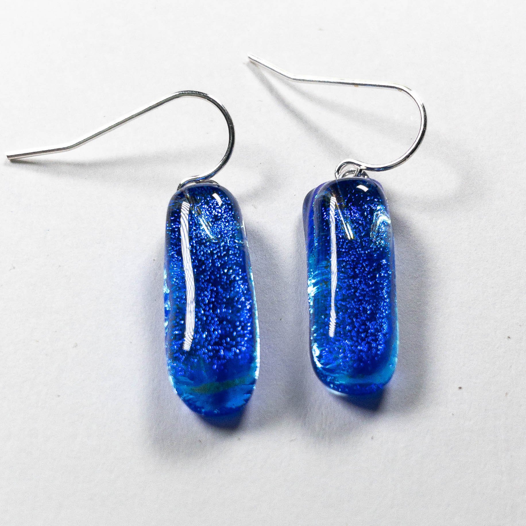 Pair of rectangle-shaped cobalt blue fused dichroic glass earrings from the Zing! collection on sterling silver hooks