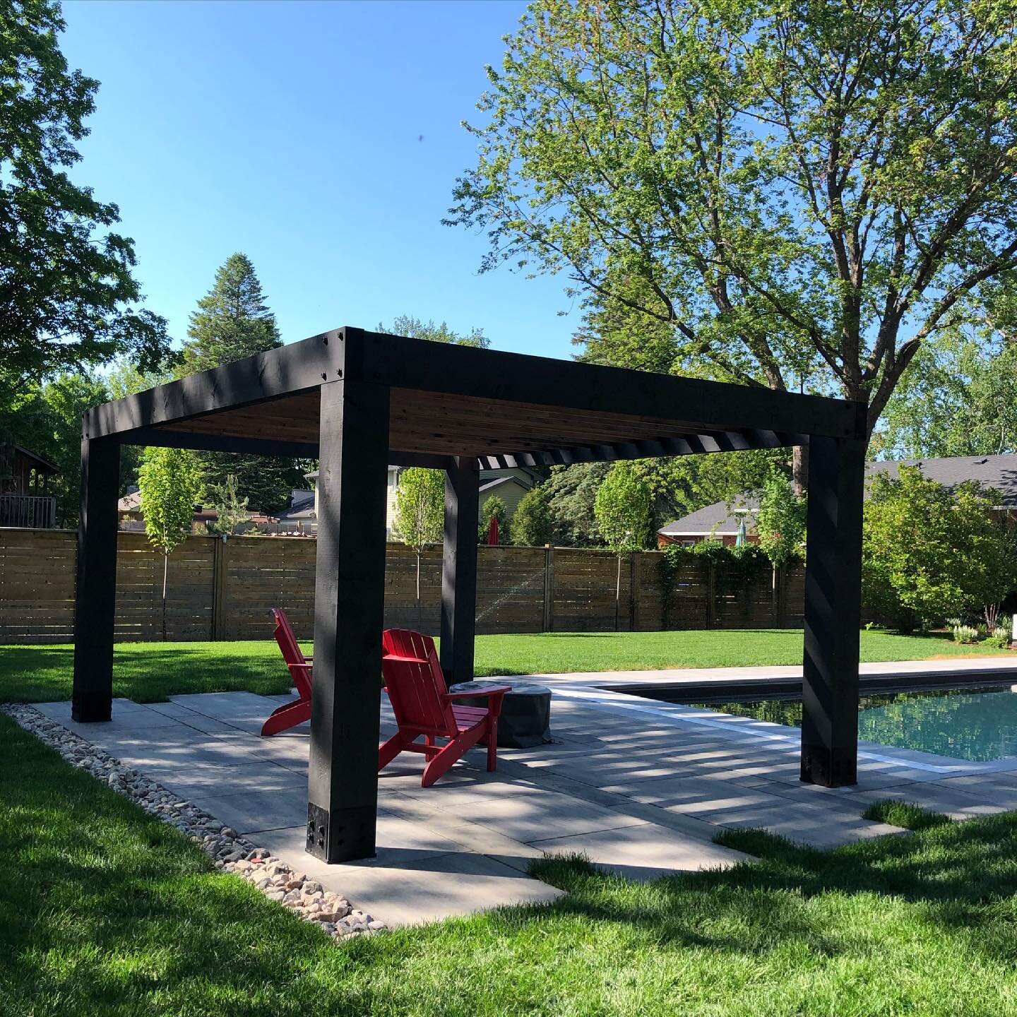 Nice shady spot to sit and enjoy an afternoon by the pool.  #lifeoutdoors #pergola #patioseason #backyard #waterfront #inspiringartscapes
