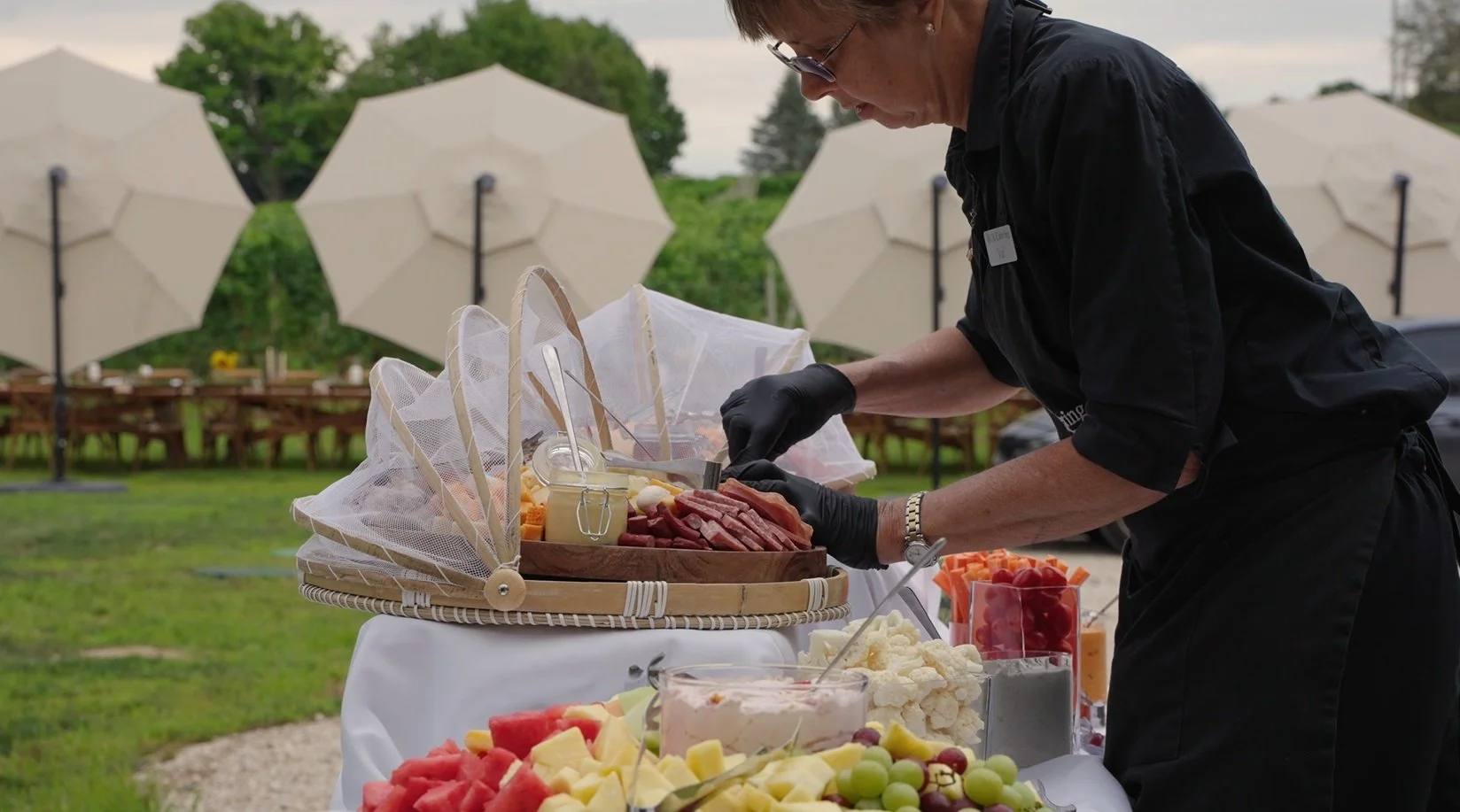 caterer setting up at Granite Ridge Vineyard during summer harvest celebration in Michigan